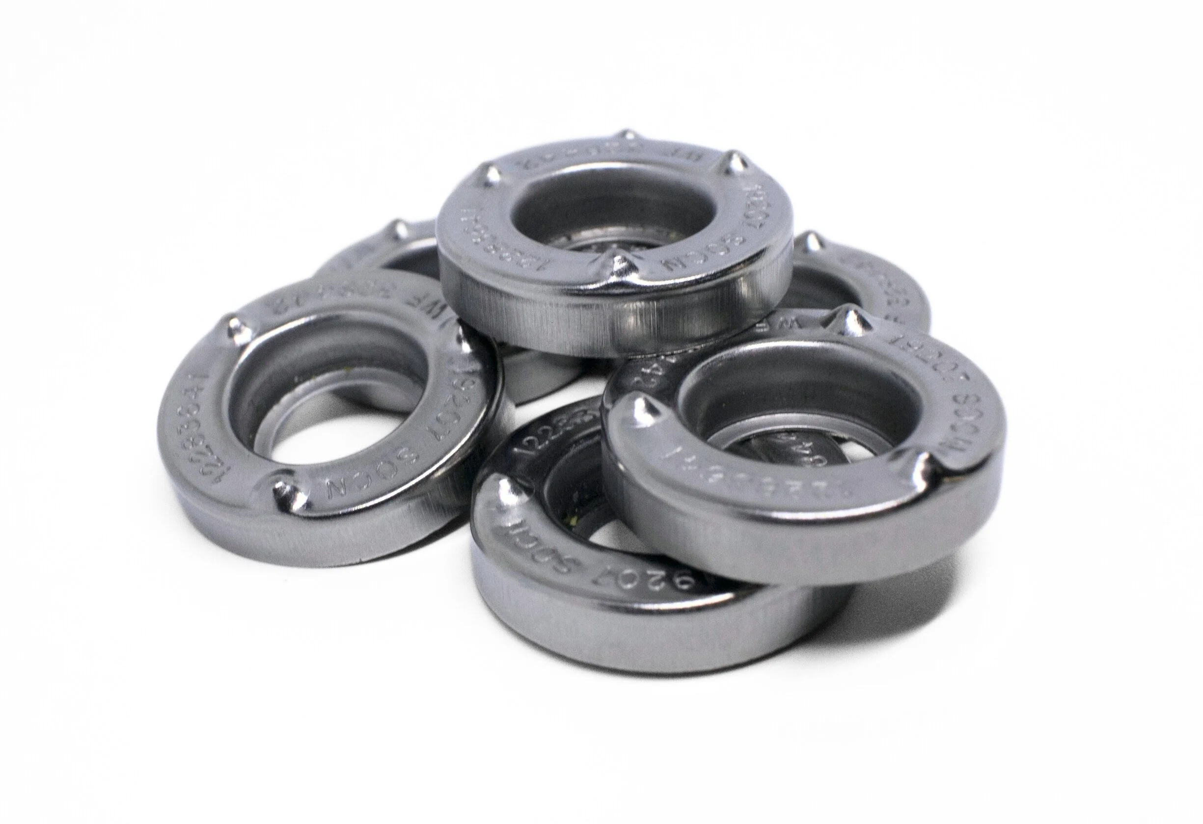 Six metal ball bearings arranged on a white background.