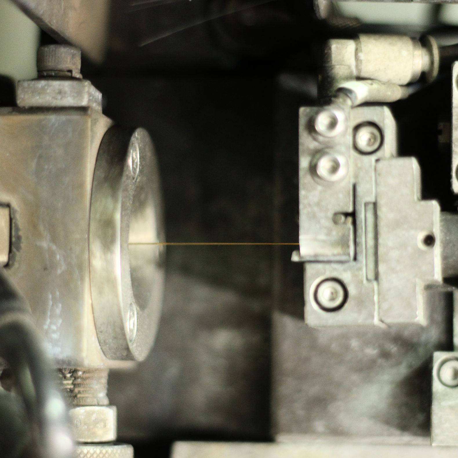 Close-up of a vintage mechanical or industrial machine part with metal components and screws.