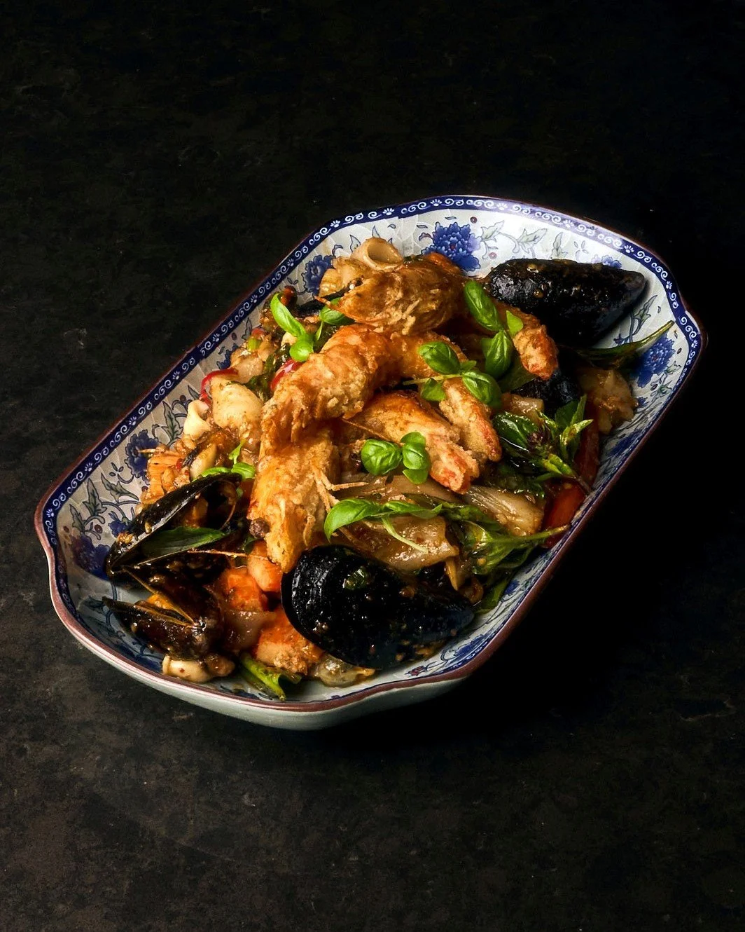 On the menu @shoreleavebos: Pad Kee Mao Talay ( ຜັດຂີ້ເມົາທະເລ) 🦐 We promise there are plenty of wok-charred noodles under all of that NE seafood. 

Book a table or order takeout and delivery at the 🔗 in bio

#bostonfoodie #laofood #southendboston 