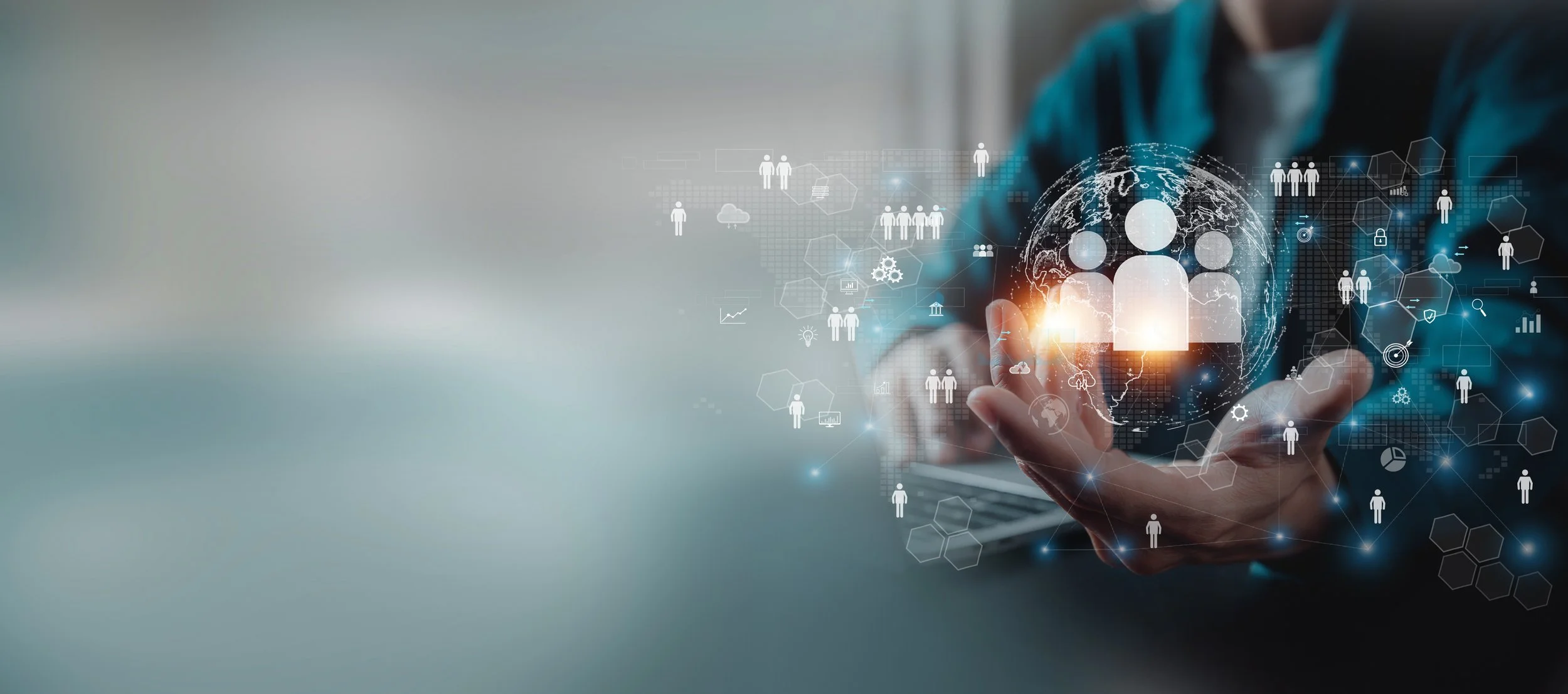 Person holding out hand with holographic digital icons of people, globe, and data graphs around it, symbolizing technology and global connectivity.