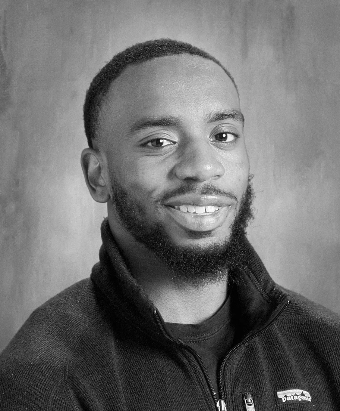 Portrait of author Marquis McCoy, founder of The McCoy Catalog, smiling in a black Patagonia fleece jacket.