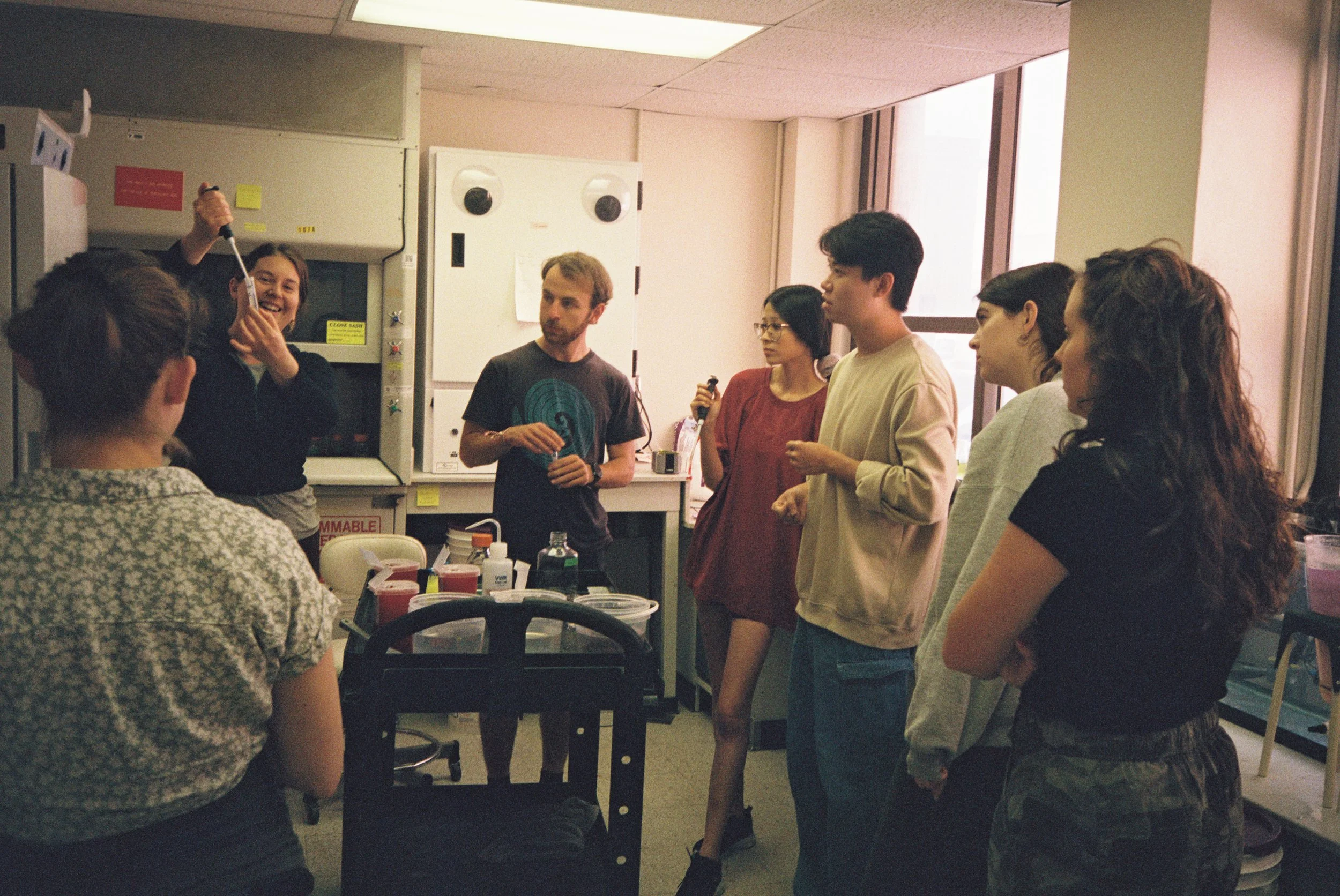 Dr. Marie Strader demonstrating spawning procedures to lab members, including grad students and undergrads.