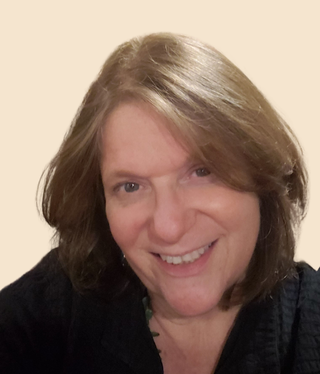A smiling woman with shoulder-length black hair, wearing a sleeveless black top, against a light blue background.