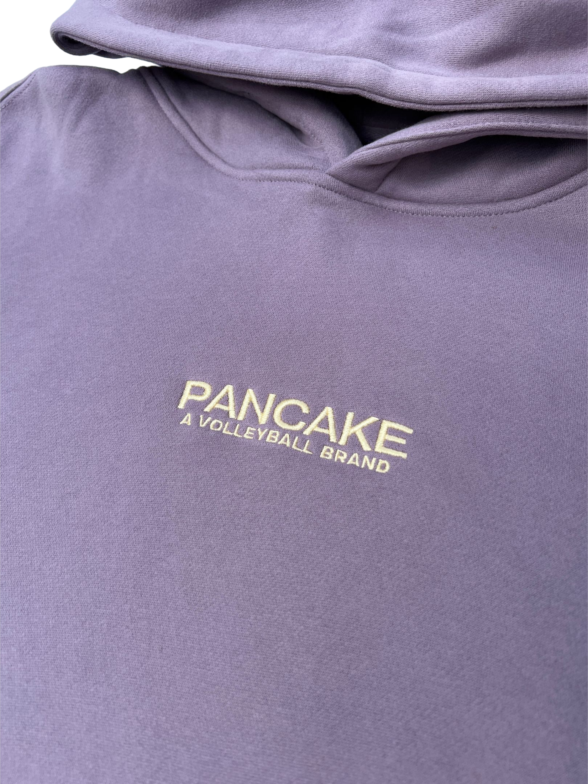 Close-up of purple Pancake Volleyball hoodie showing embroidered logo text, premium volleyball clothing designed for everyday streetwear wear