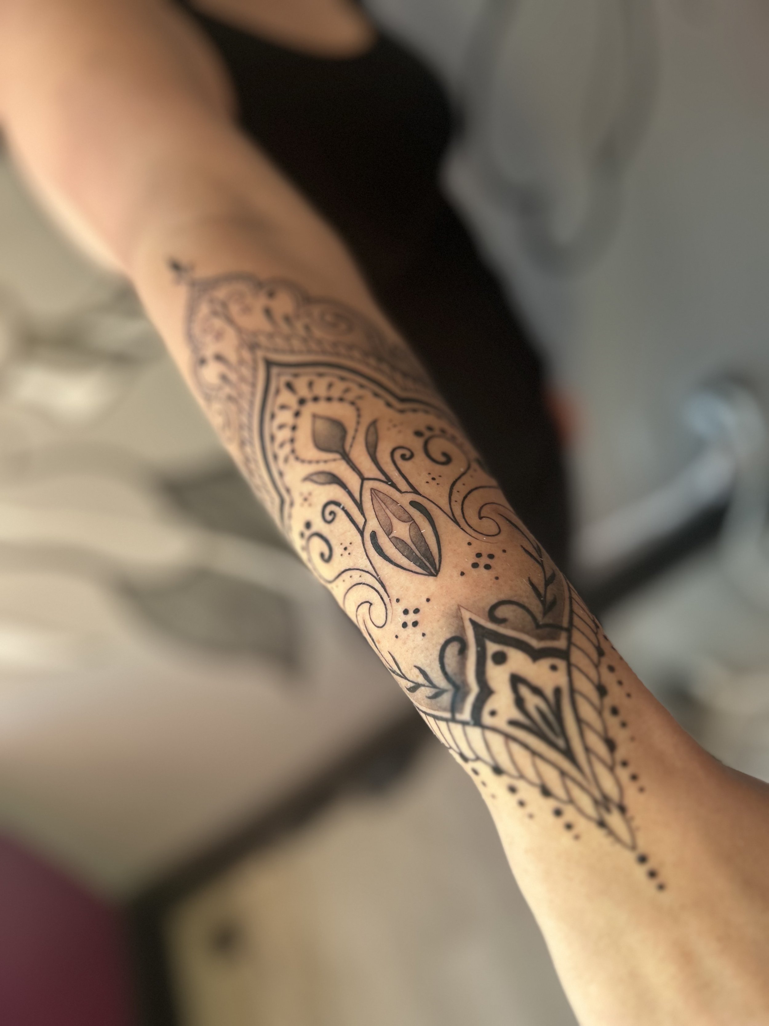 Ornamental half sleeve tattoo