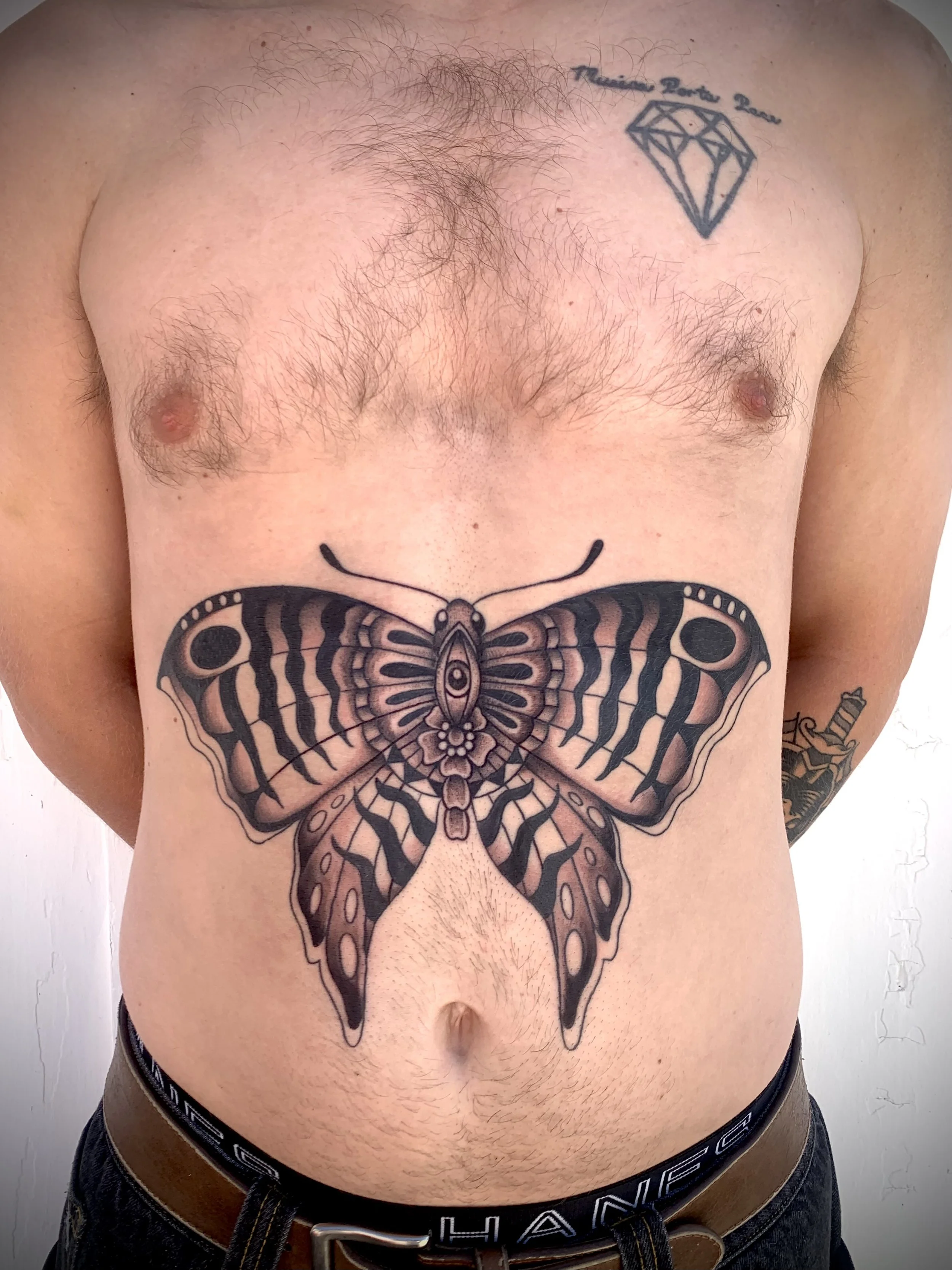 Stomach butterfly, traditional, black and grey tattoo