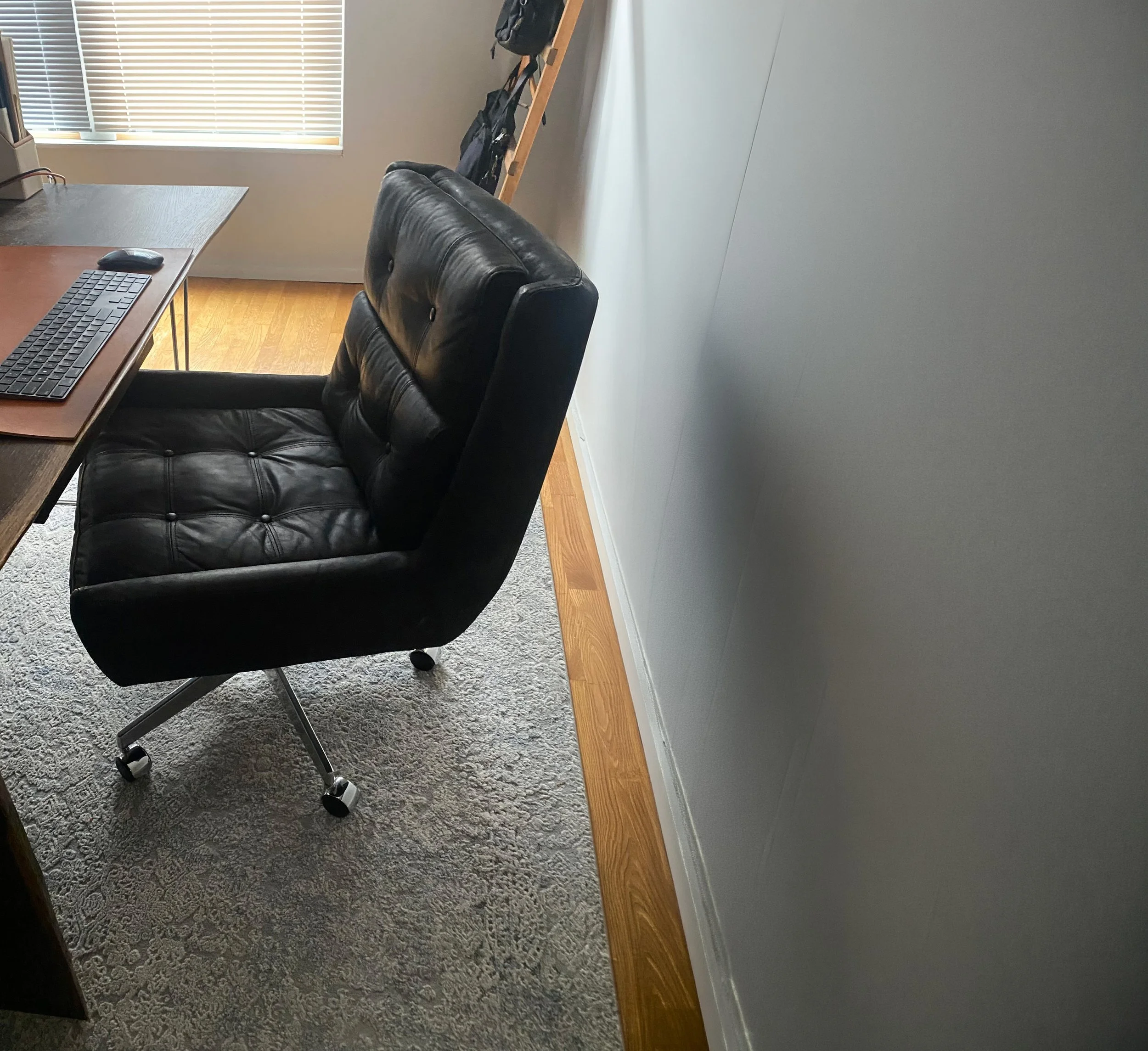 RH office chair in a minimalist workspace illustrating premium positioning through context and presentation.