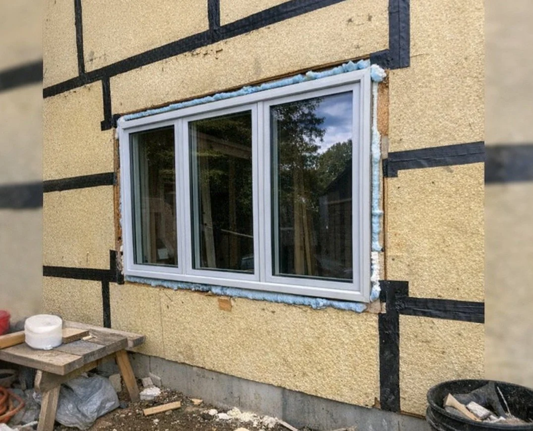 Continuous exterior insulation and taped seams on a new home wall