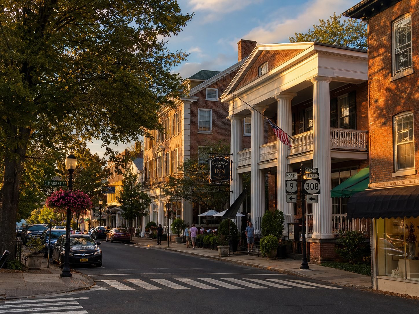 Iconic view of downtown Rhinebeck, NY with historic brick buildings, tree-lined streets, local shops, the Beekman Arms Inn, and walkable Hudson Valley village character.