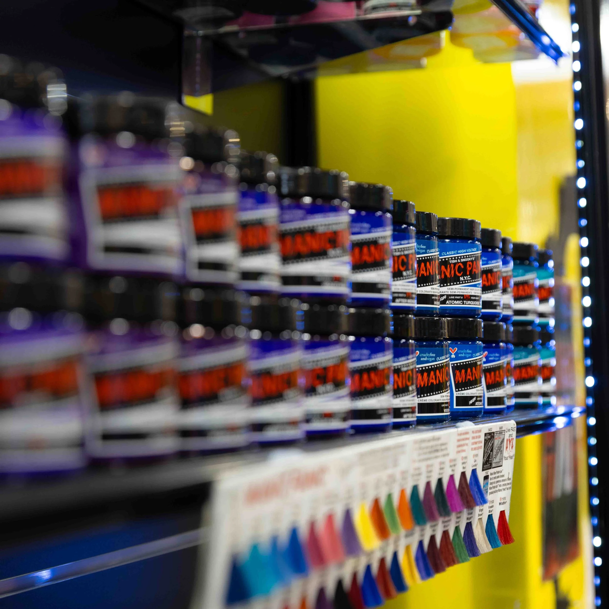 Shelves stocked with jars of Blue Manic Panic semi-permanent hair color in a store aisle.