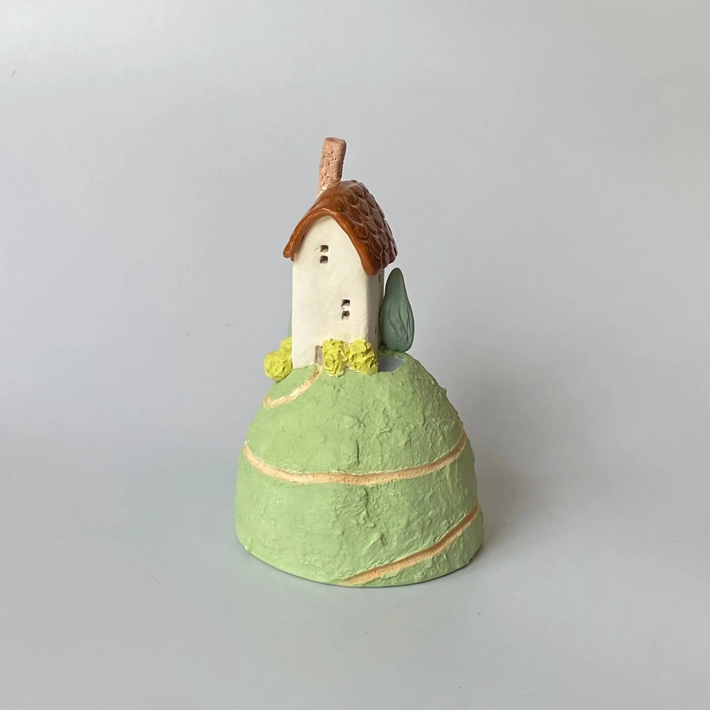 Little House on a Hill with Pond[variation].  2026.
Glazed and Underglazed Ceramic.
 H 11cm W 7cm.