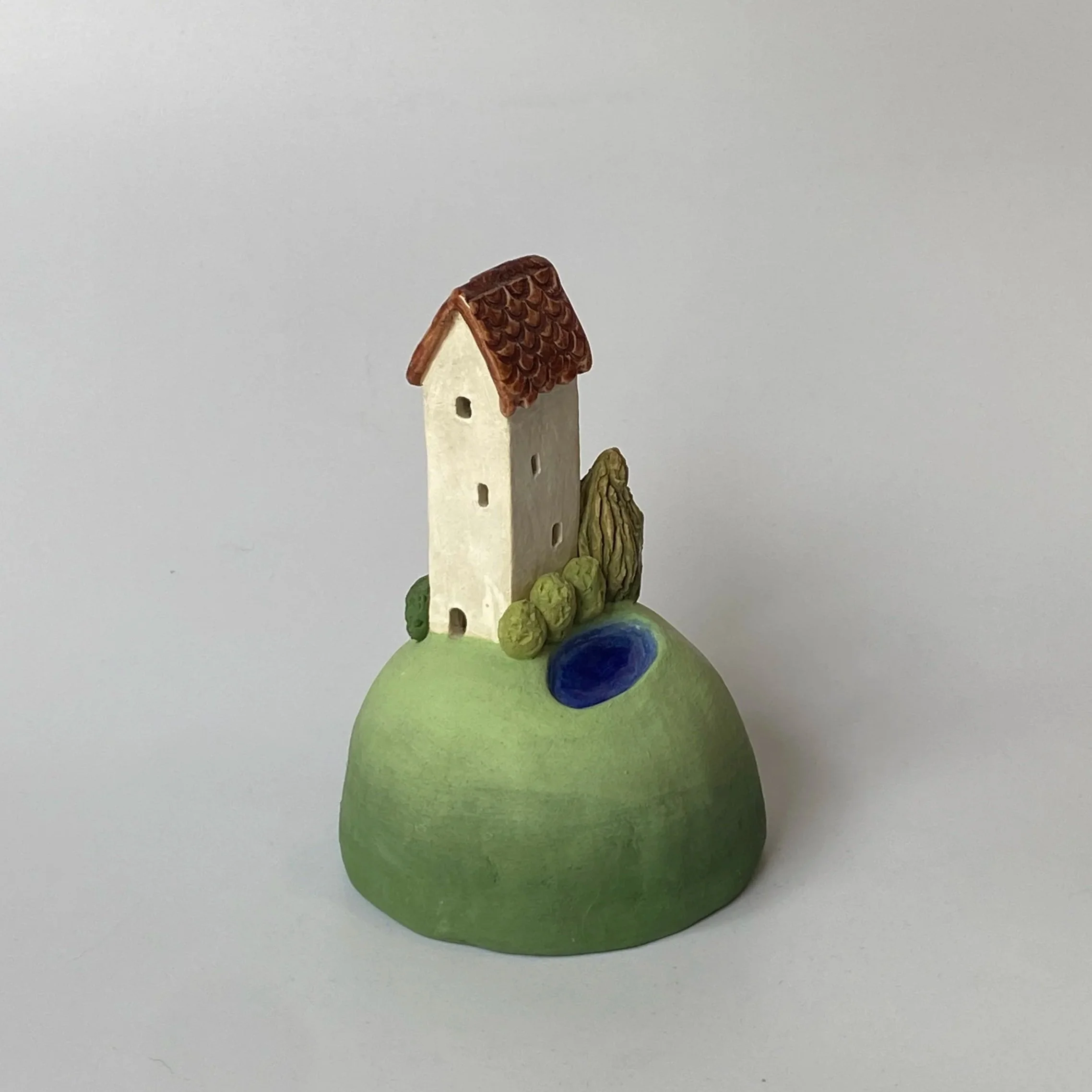 Little House on a Hill with Pond[variation]. 2025.
Glazed and Underglazed Ceramic.
H 10.5cm W 7cm.
