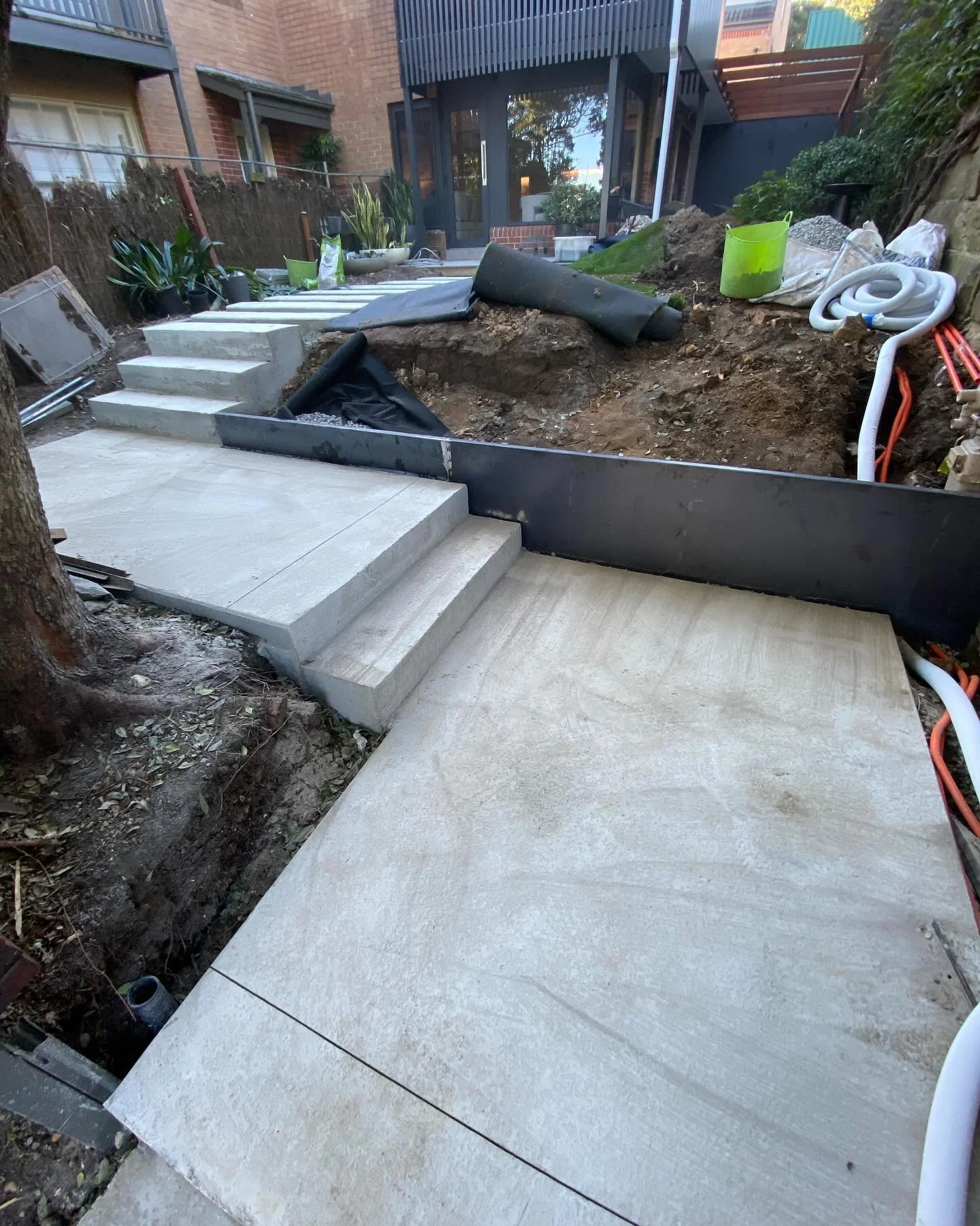 The Hill project starting to take shape with under-paving concrete complete and the first of the corten steel walls going up today.