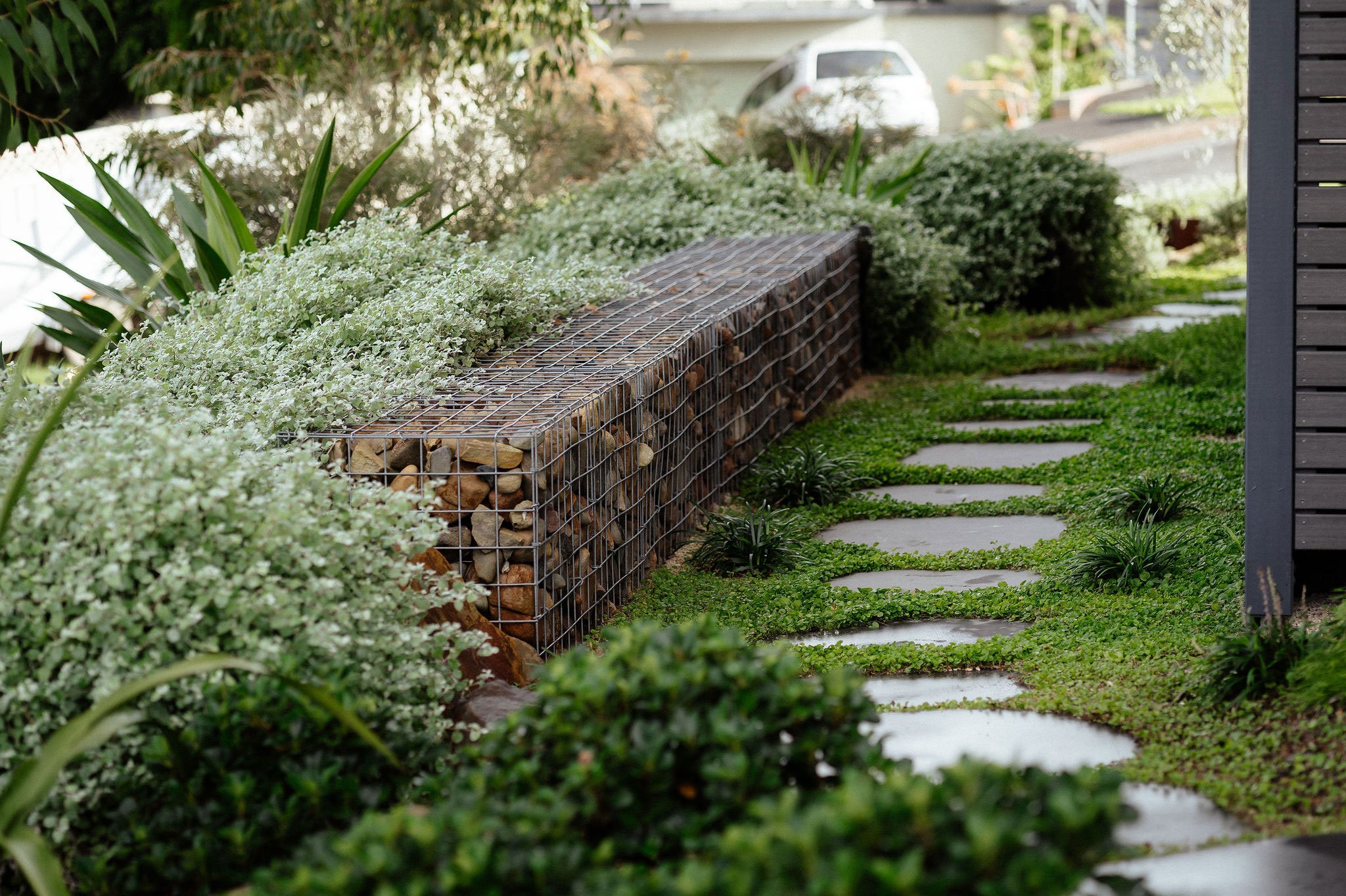 TG-Gardenscapes_Our-Projects_27-Ridgeway-Crescent_Side-View-of-Large-Stepping-Stones-Retaining-Wall-with-Rocks.jpg