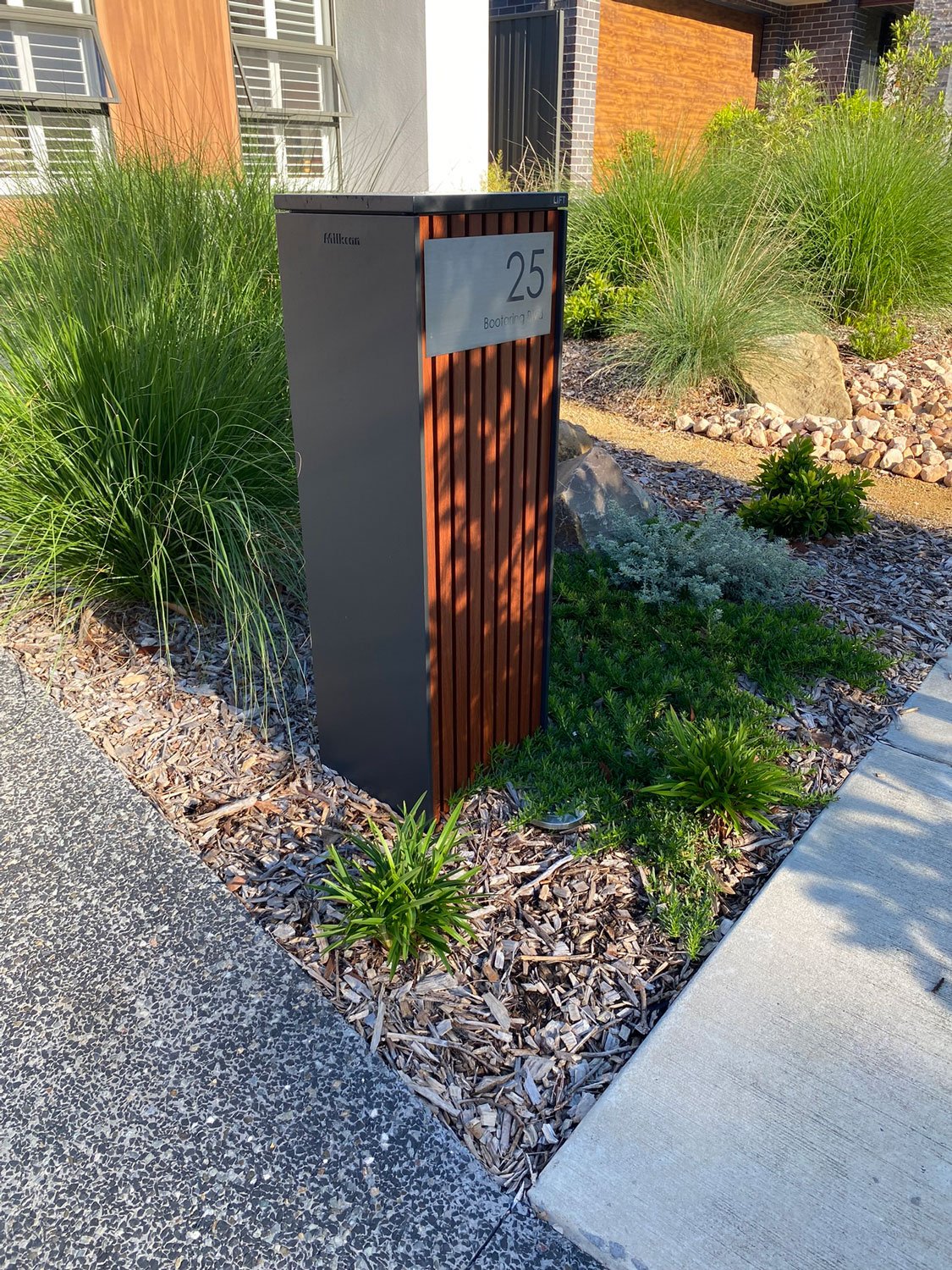 TG-Gardenscapes_Our-Projects_Edgeworth_Garden-with-Large-Stepping-Stones-with-Plants-around-Letterbox.jpg