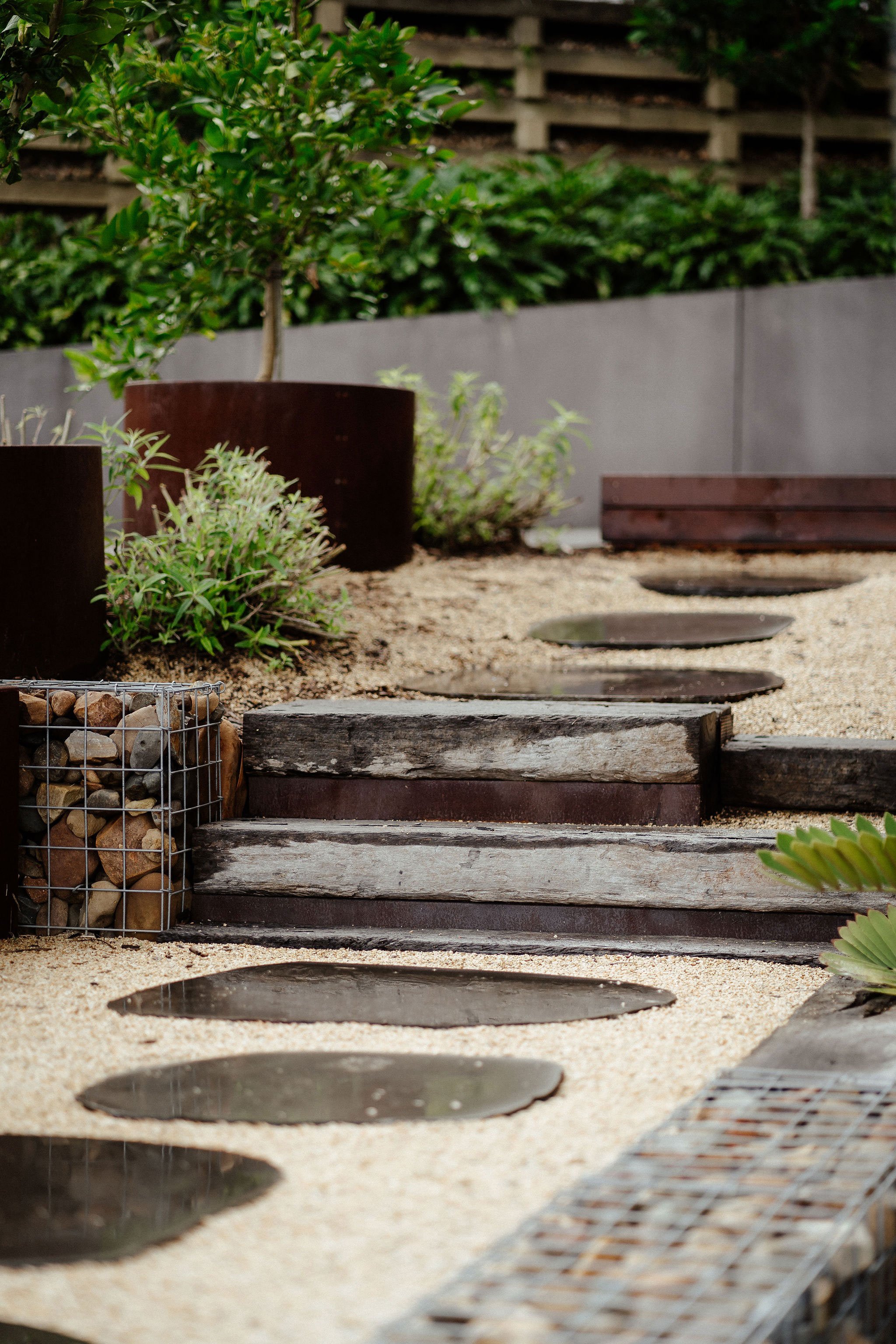TG-Gardenscapes_Our-Projects_27-Ridgeway-Crescent_Large-Stepping-Stones-Retaining-Wall-with-Rocks-with-Wood-Steps.jpg