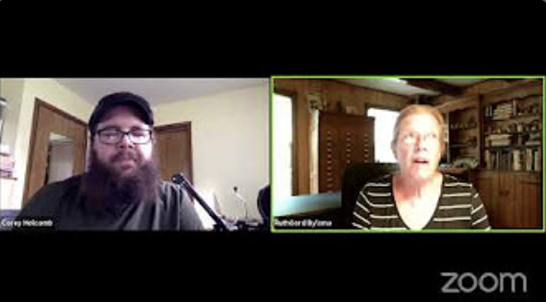 Screenshot of a Zoom video call with a man with a beard and glasses on the left and a woman with glasses on the right, in a room with bookshelves.