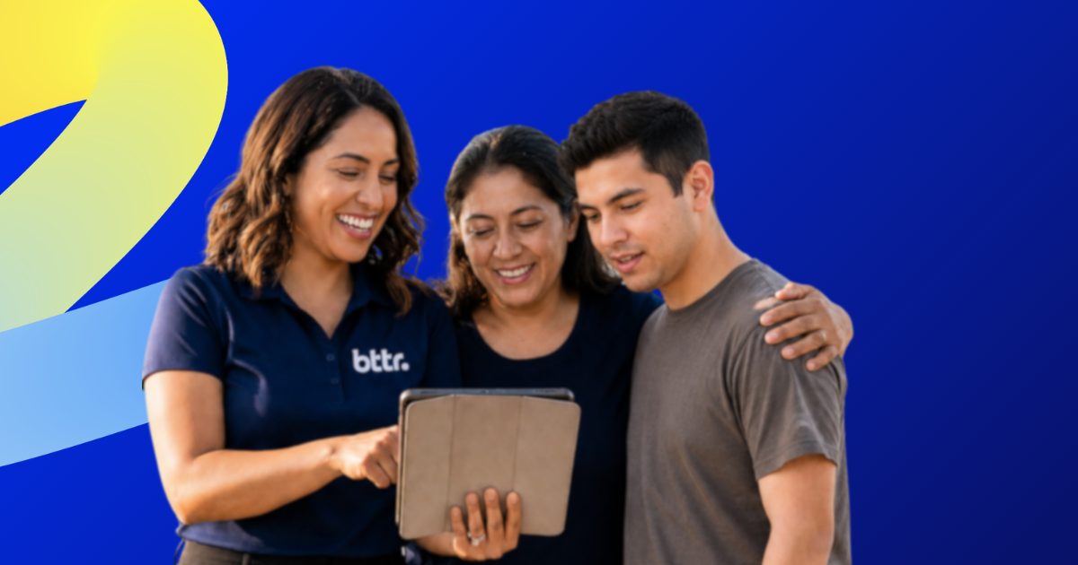 Two women and a man reviewing a plan on a tablet, one wearing a navy BTTR shirt, showing responsive communication from the BTTR Living team.