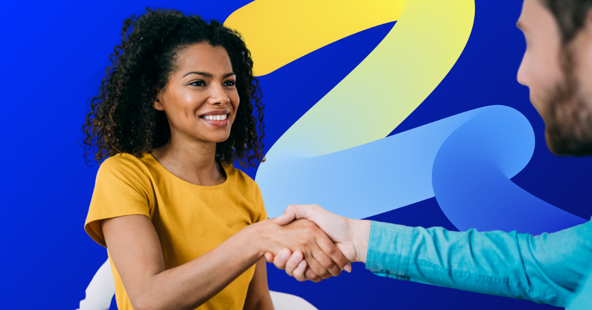 A woman in a yellow shirt shaking hands with a man, representing BTTR Living partnerships and community collaboration.