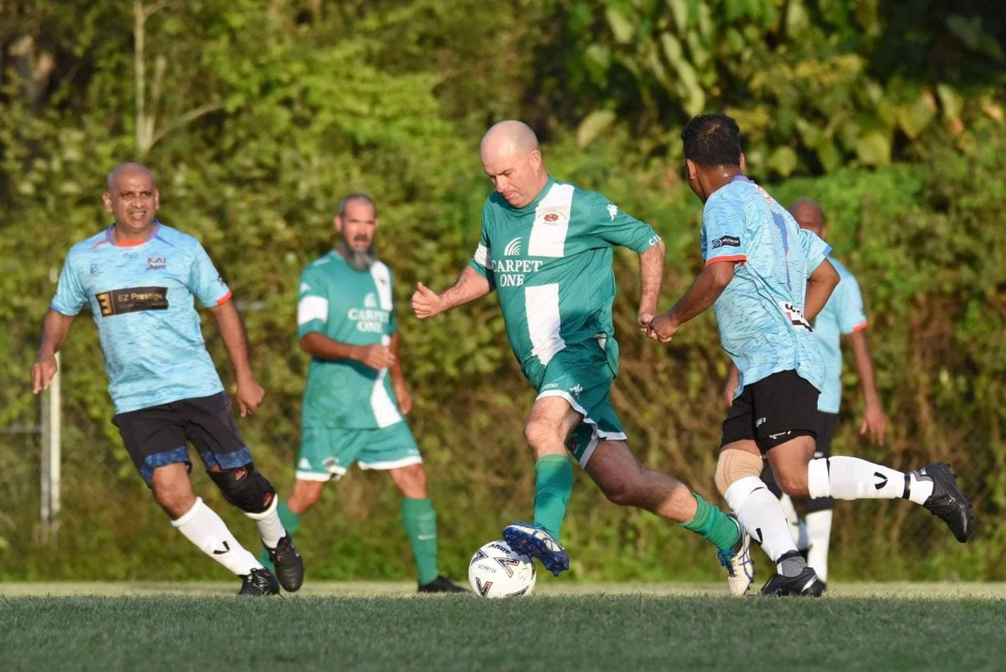Soccer players on a field competing for the ball during a match.