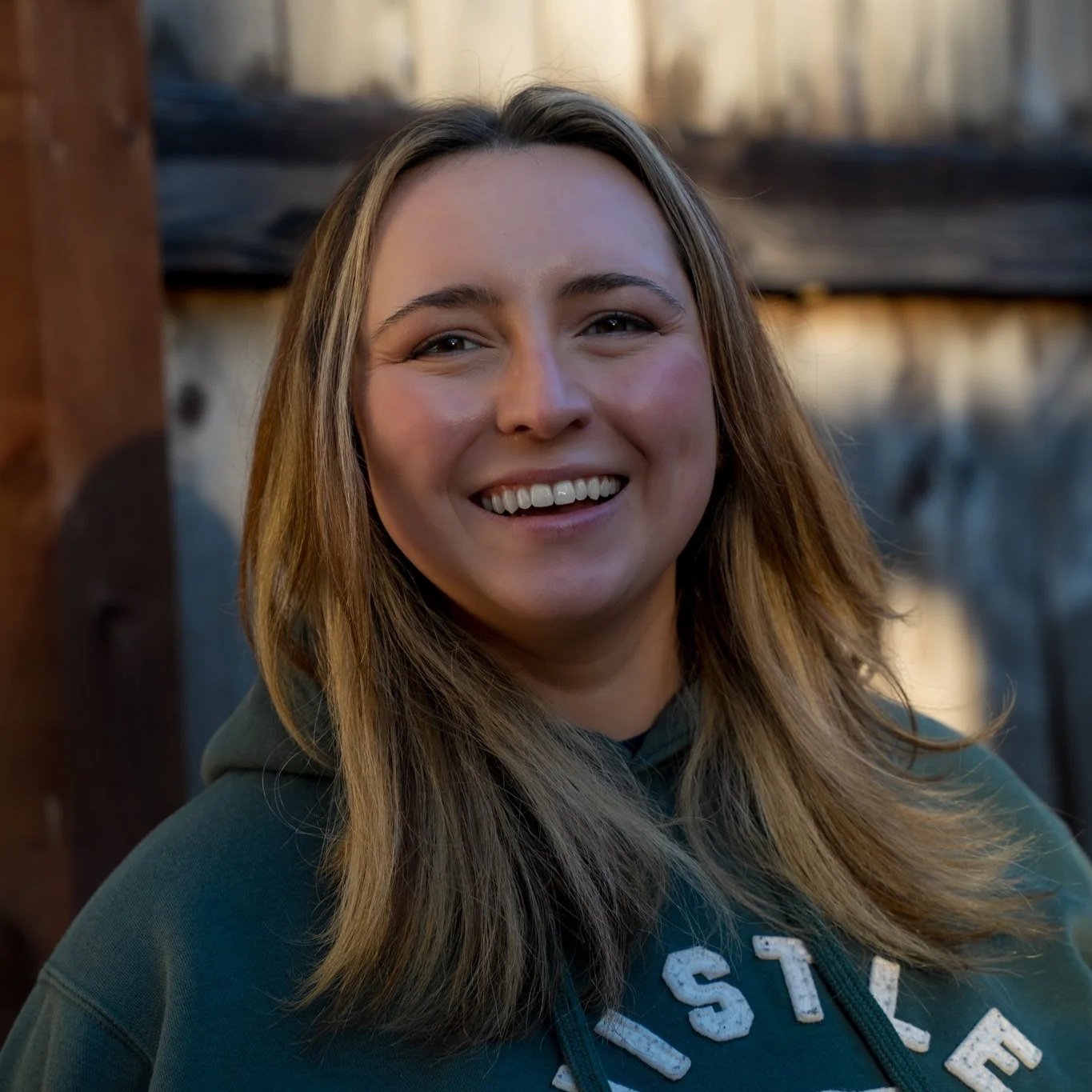 Annika, co-owner of Big Blue Pressure Washing, outdoors in Bellingham
