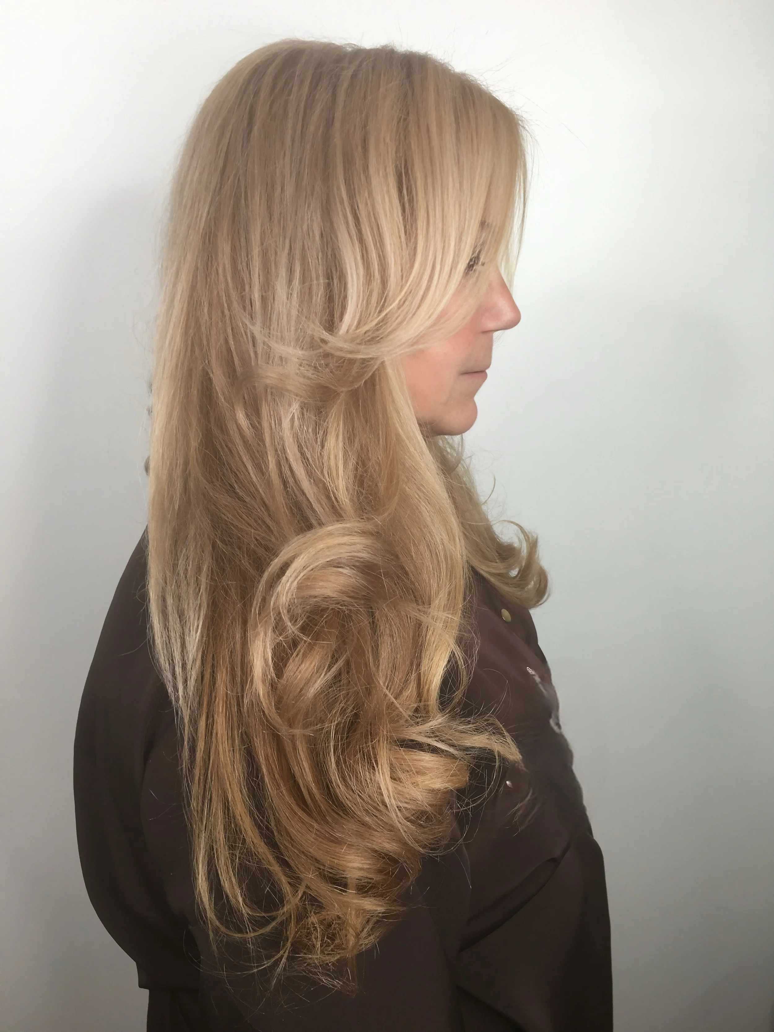 After: Using four carefully formulated color blends and no bleach, we enhanced her natural beauty without compromising the integrity of her hair.