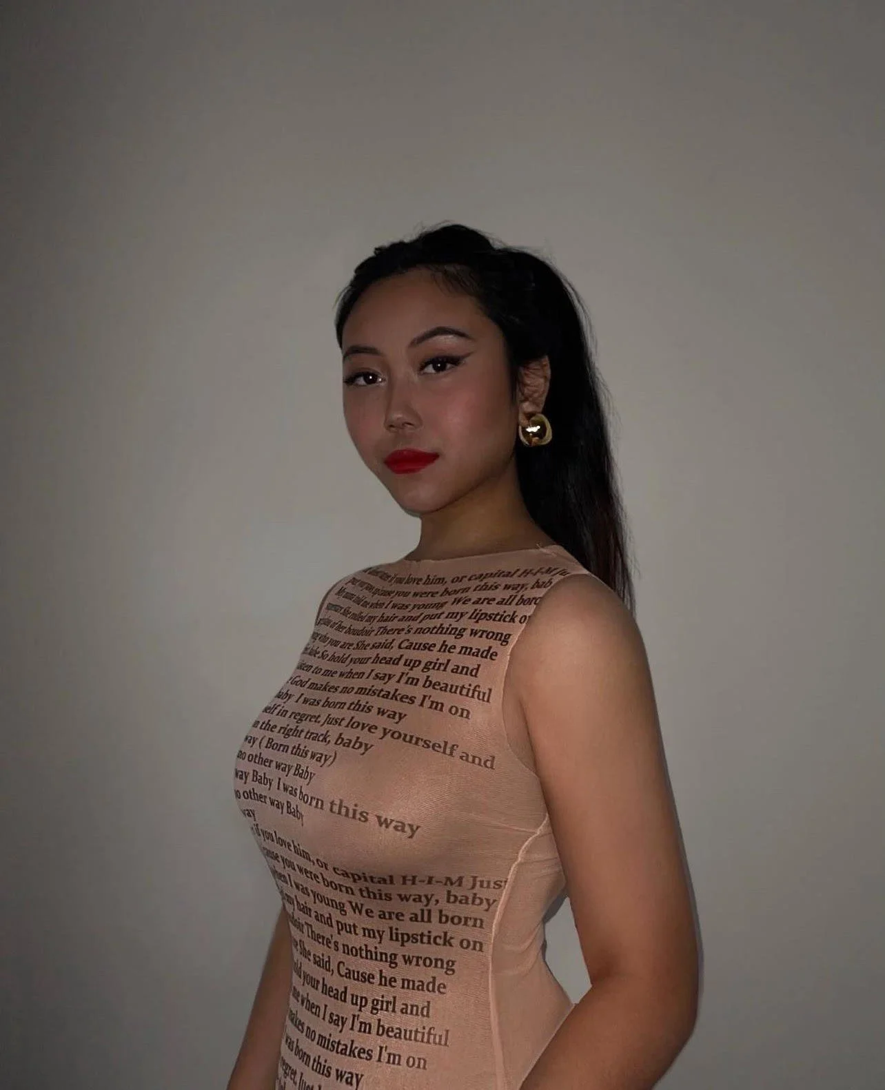 PR Team Member Destiny, with hair in a ponytail and a dress with writing on it.