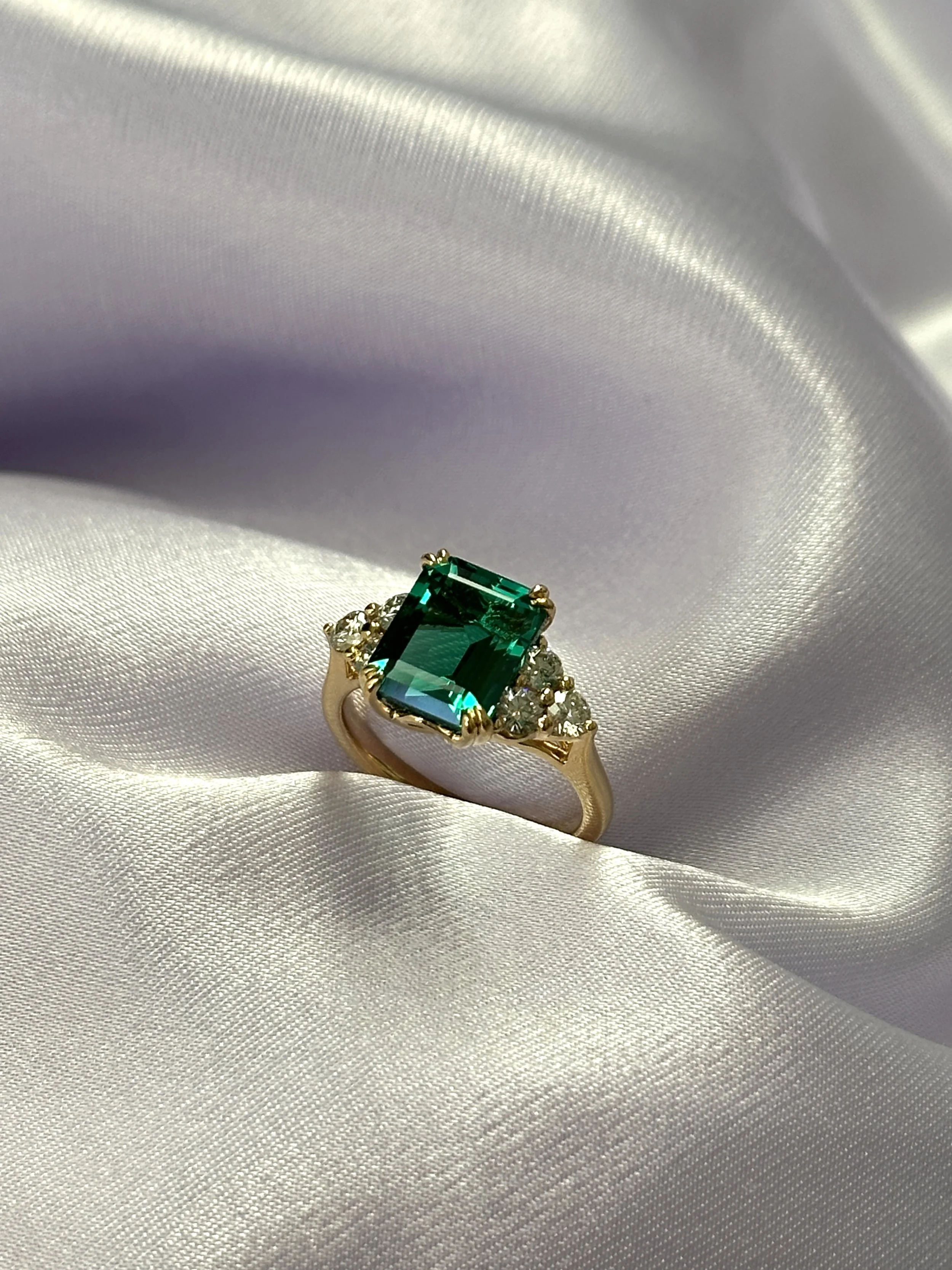 Emerald with side stones