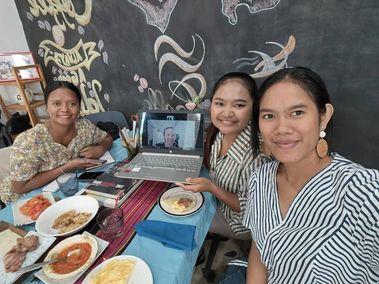 Three women from Timor-Leste sitting together smiling