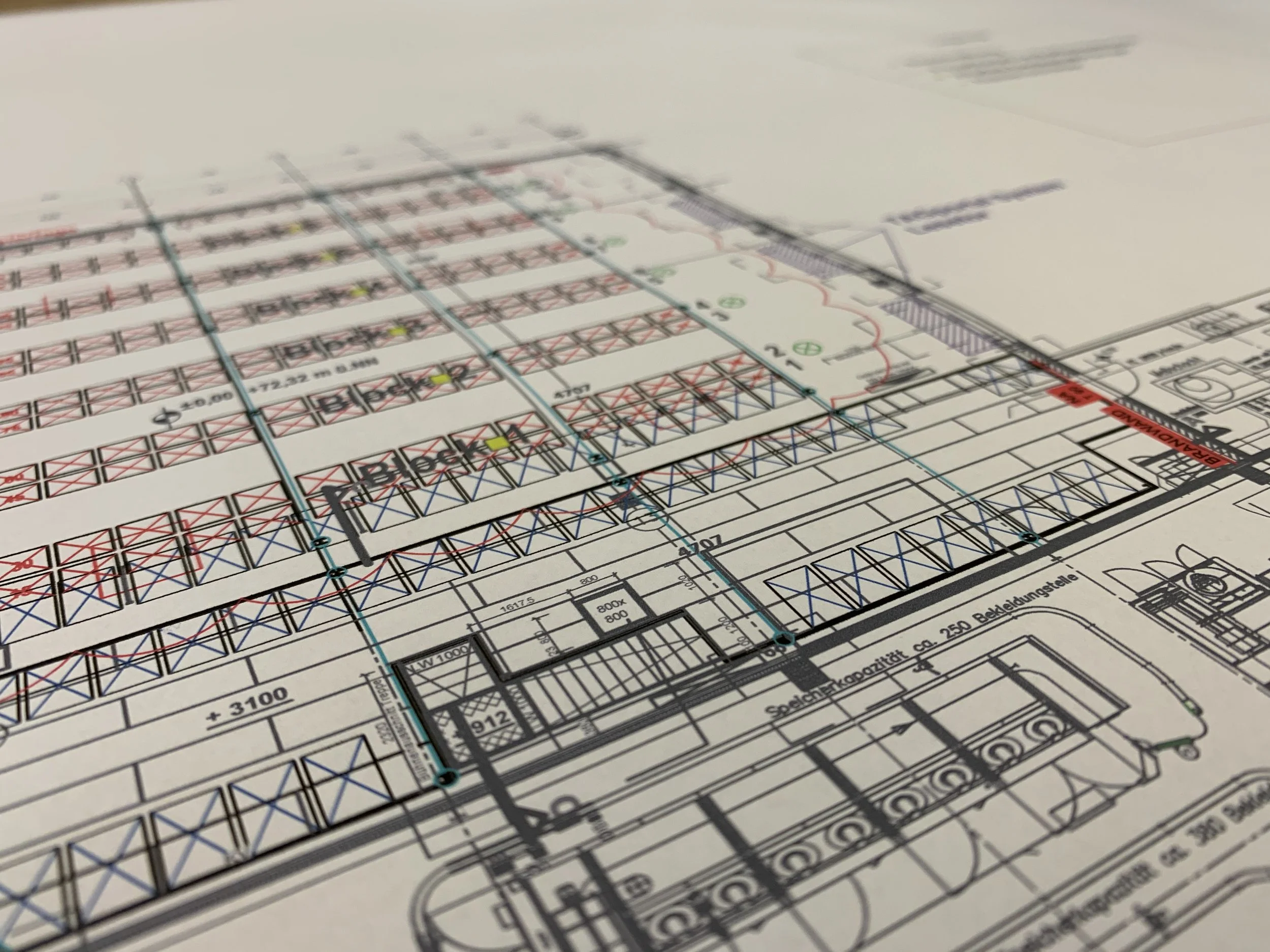 Detaillierter Bauplan mit verschiedenen Linien, geometrischen Formen und technischen Angaben, wahrscheinlich für den Bau eines Gebäudes oder einer Struktur.