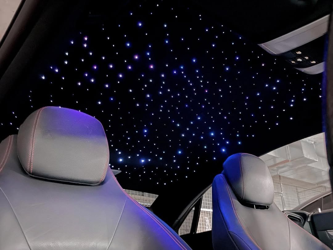 Car interior with leather seats and a starry LED ceiling lights