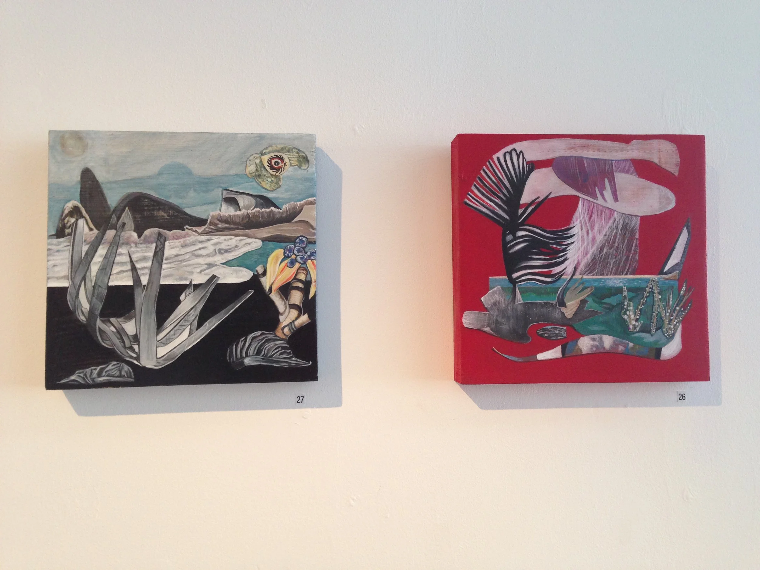 Two abstract paintings on a white gallery wall, numbered 27 and 26. The left painting features surreal elements with black, gray, blue, and yellow accents, depicting abstract shapes and figures. The right painting has bold red background with abstrac