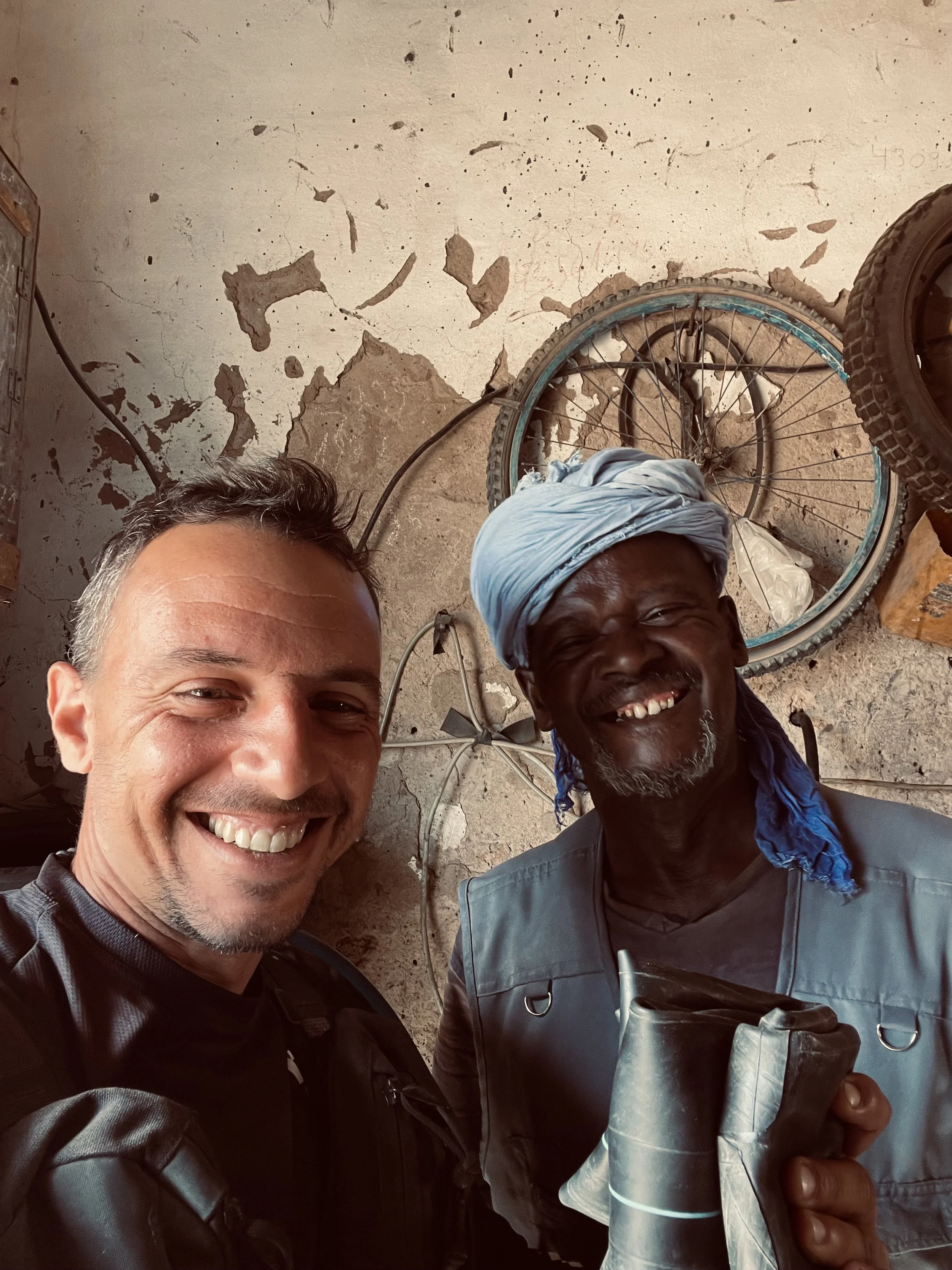 João Beltrão founder of Beyond T7nnis with a tire repair man in Mauritania
