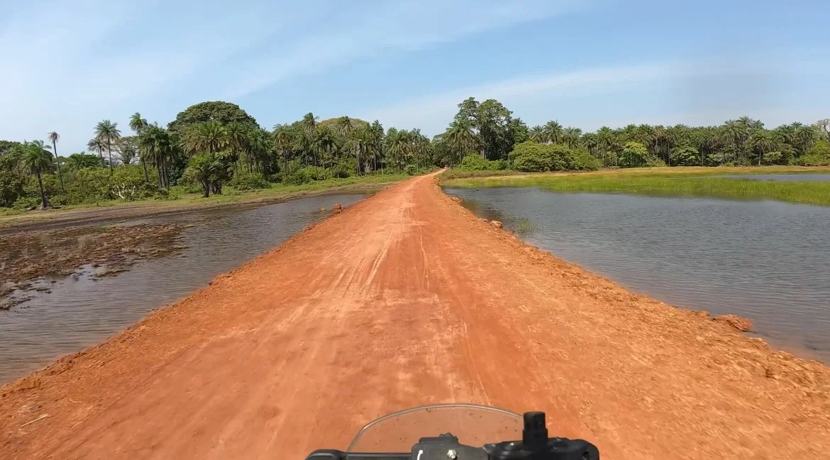 João Beltrão founder of Beyond T7nnis riding his Yamaha Ténére 700 motorcycle on the Casamance river, Senegal

