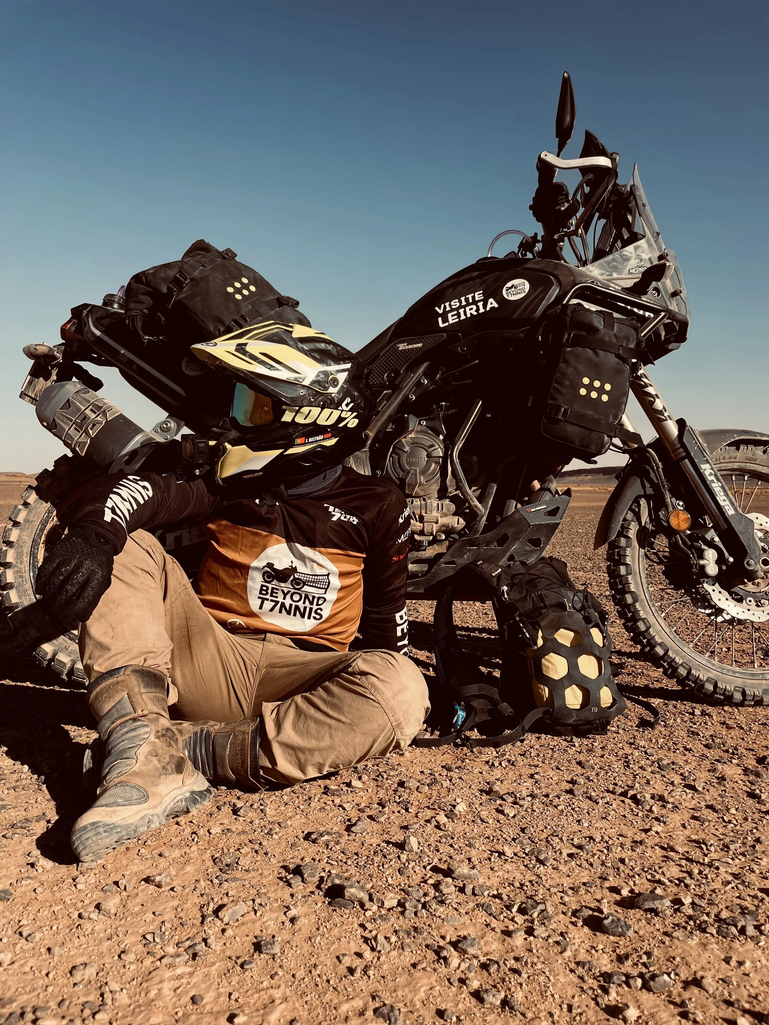 João Beltrão founder of Beyond T7nnis with his Yamaha Ténére 700 motorcycle in sahara desert
