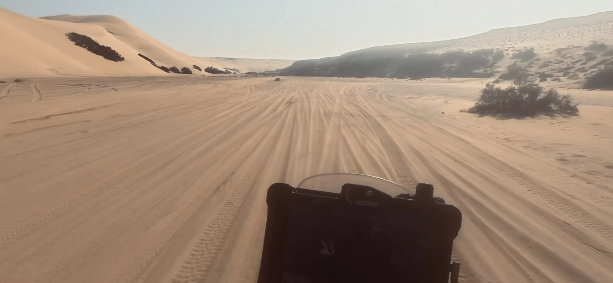 João Beltrão founder of Beyond T7nnis riding his Yamaha Ténére 700 motorcycle in the dunes at Plage Blanche
