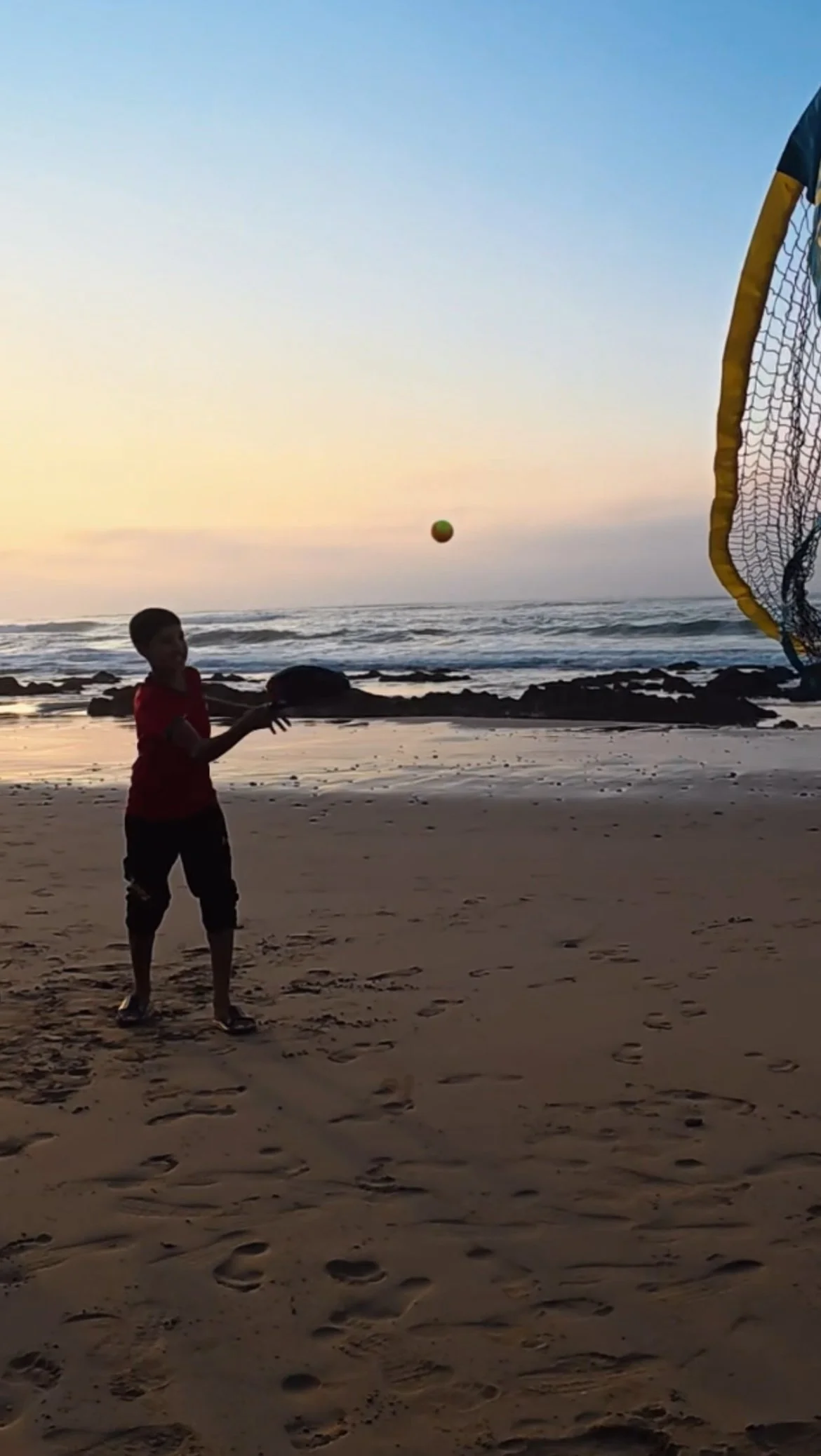 Kid playing Beach Tennis in Foum Assaka at Le Rayon Vert during a Beyond T7nnis mission