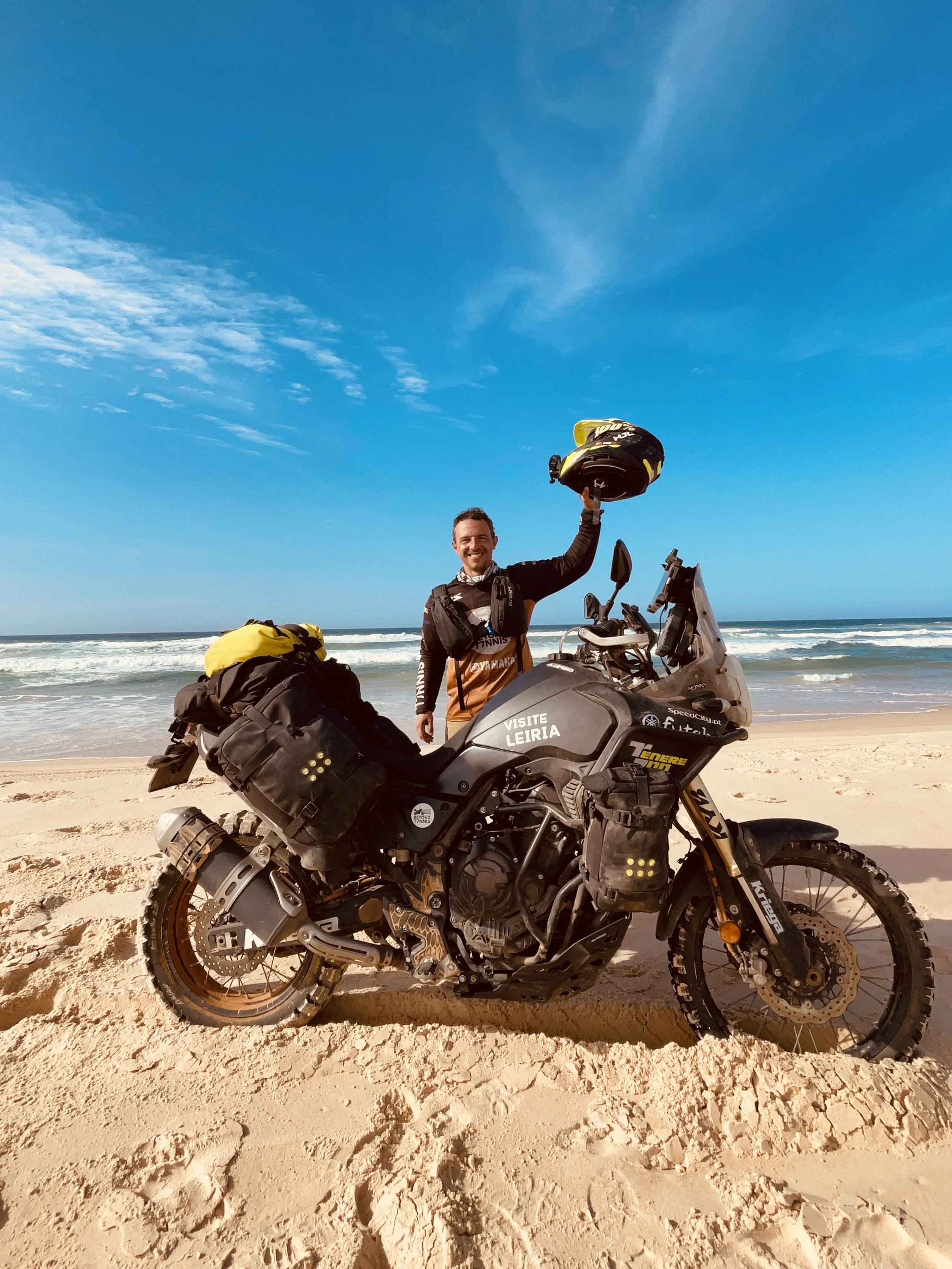 João Beltrão founder of Beyond T7nnis with his Yamaha Ténére 700 motorcycle in Dakar beach
