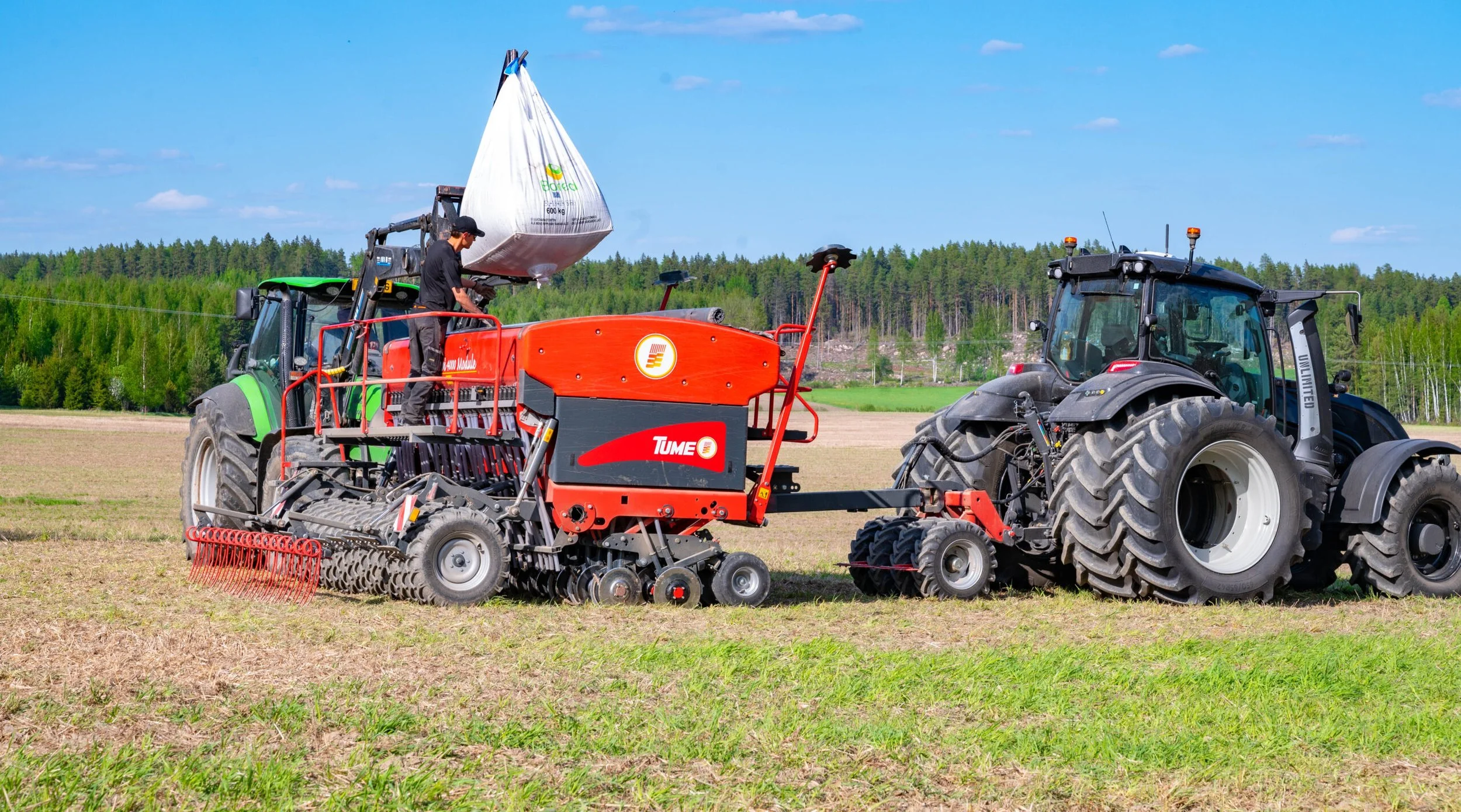 Nova Combi being filled by front end loader tractor