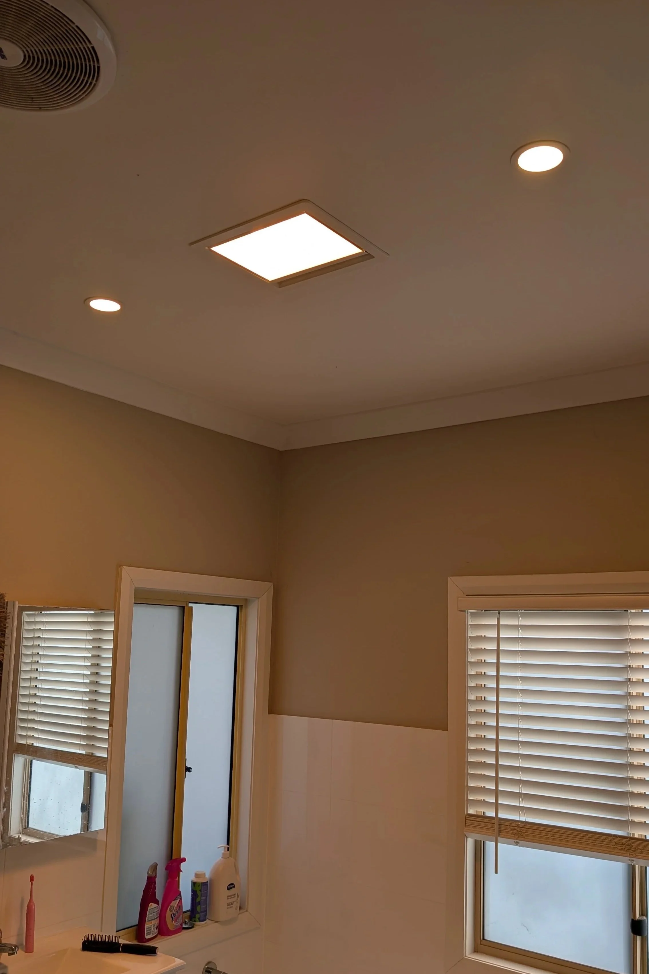 IXL heat lamp in bathroom between two downlights