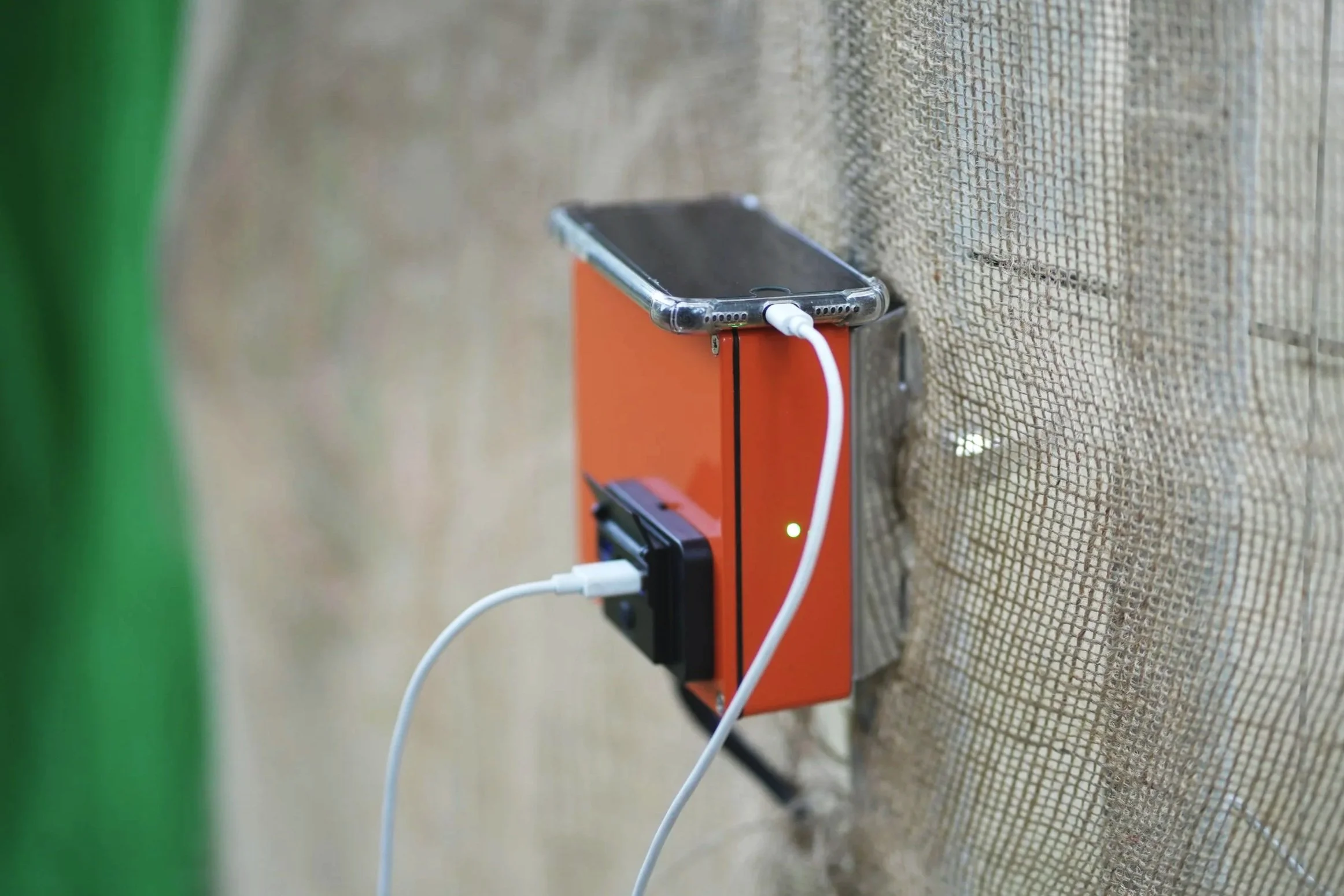 Smartphone on a solar charging station connected to usb  power outlet