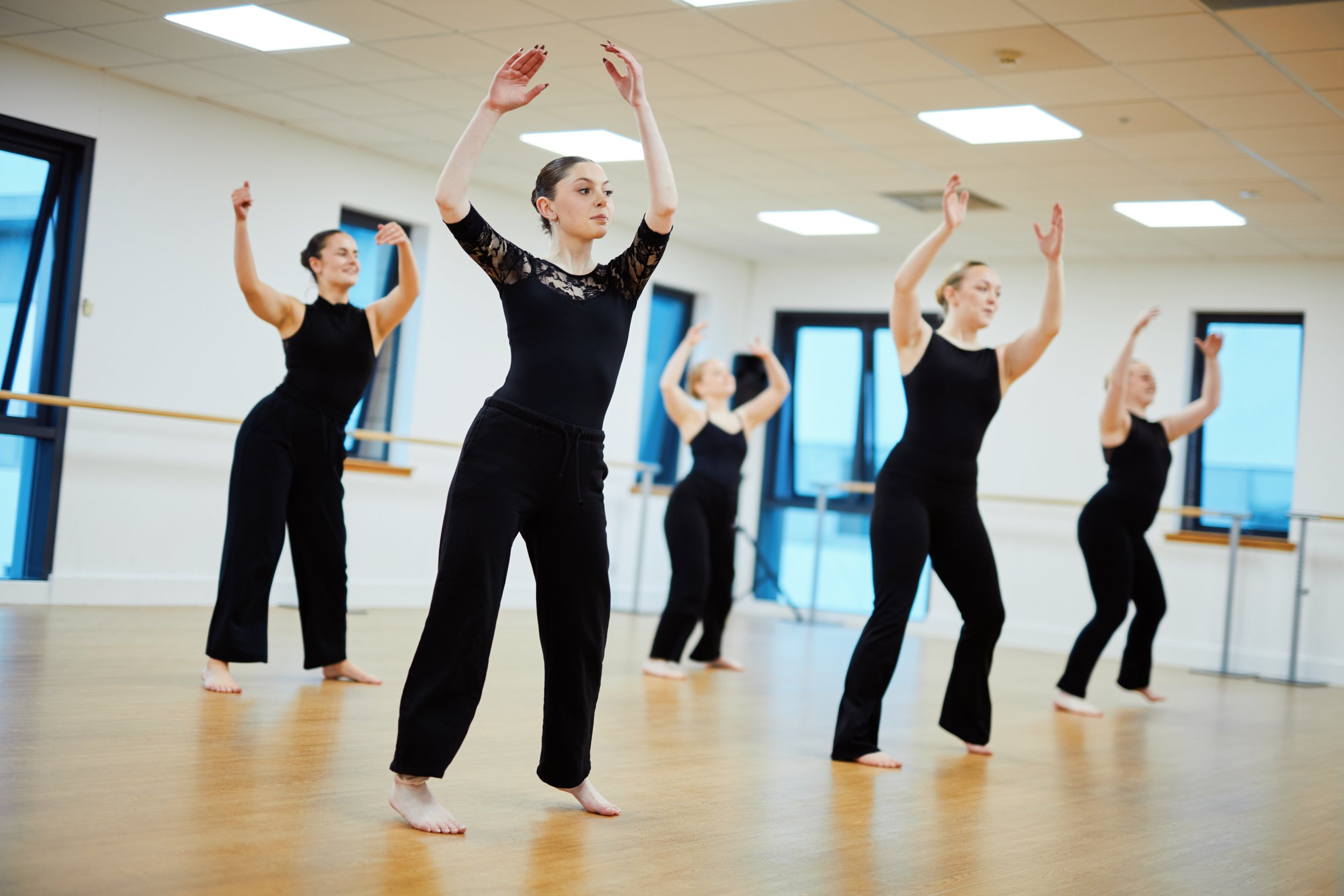 Group of Dancers dancing in a studio in black clothing