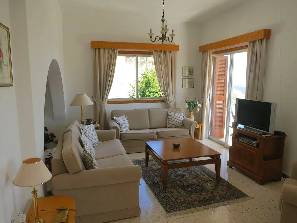 Margarita Villa sitting room with sofas, coffee table and a tv