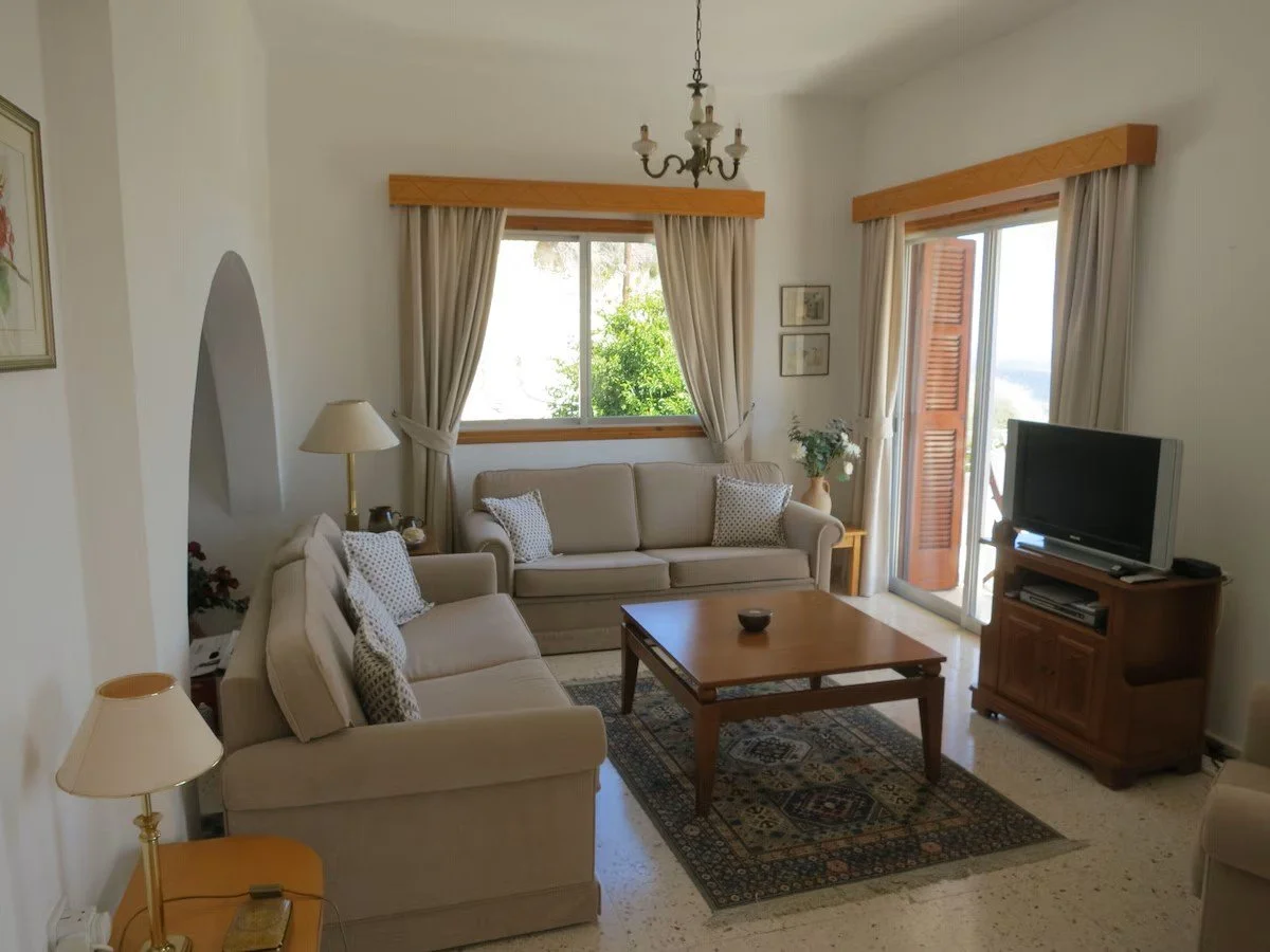 Margarita Villa sitting room with sofas, coffee table and a tv