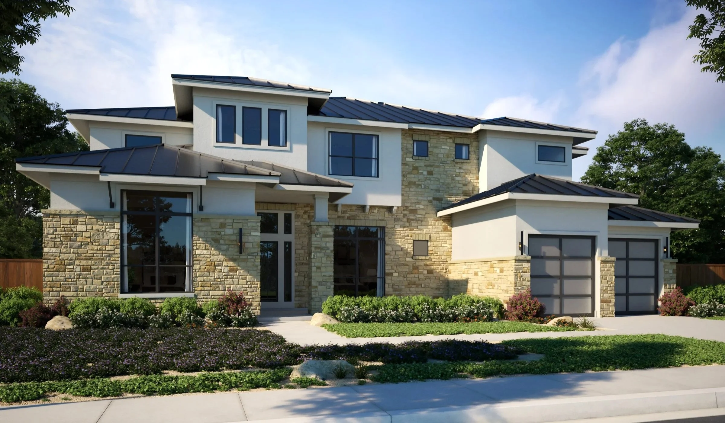 A modern two-story house with a stone and white exterior, large windows, and a black metal roof. The front yard has green bushes and colorful flowers, and a driveway with a garage door is visible on the right side.