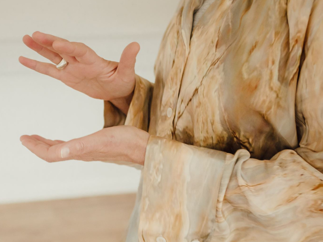 womans hands in silk shirt