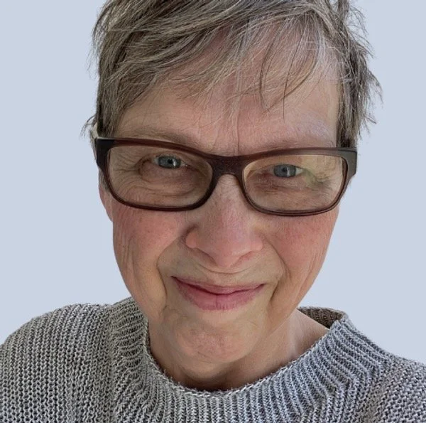 woman with glasses smiling