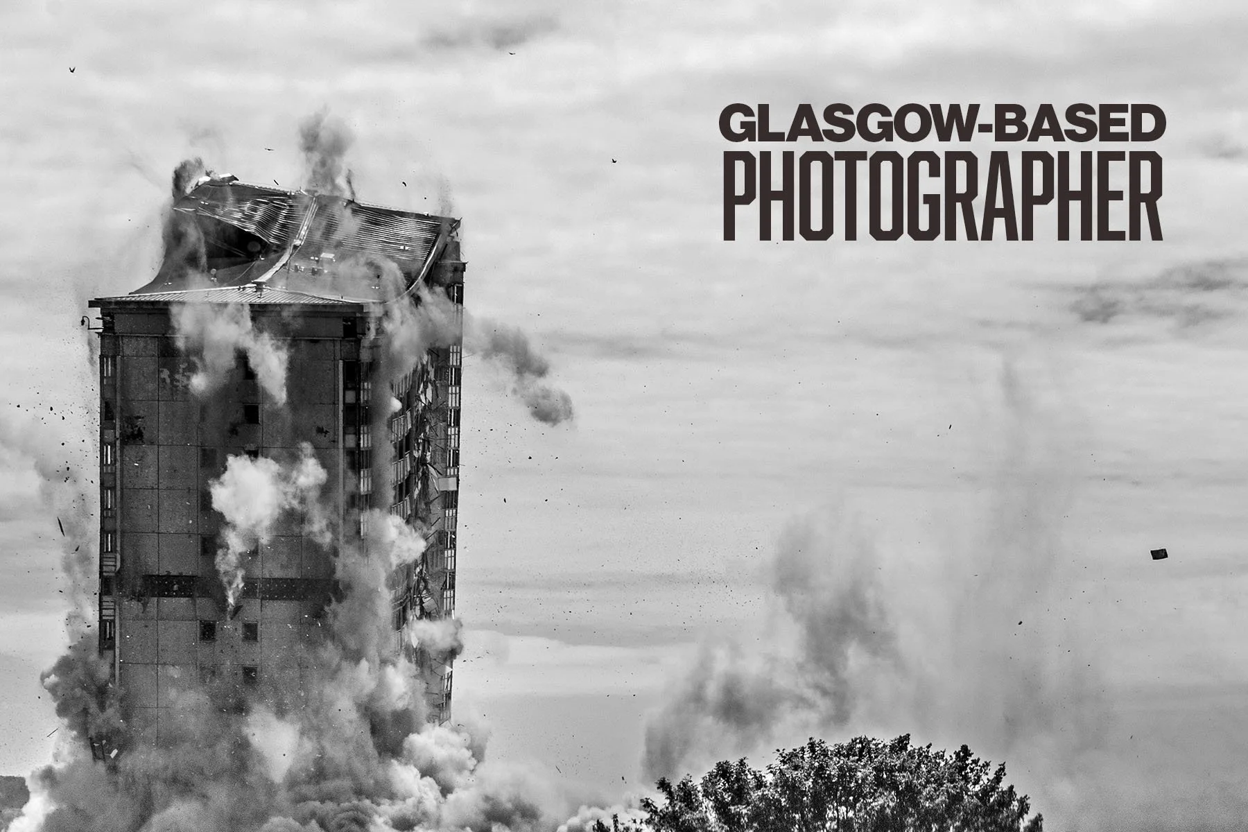Black and white photo of Glasgow's Caledonia Road flats collapsing with smoke and dust.