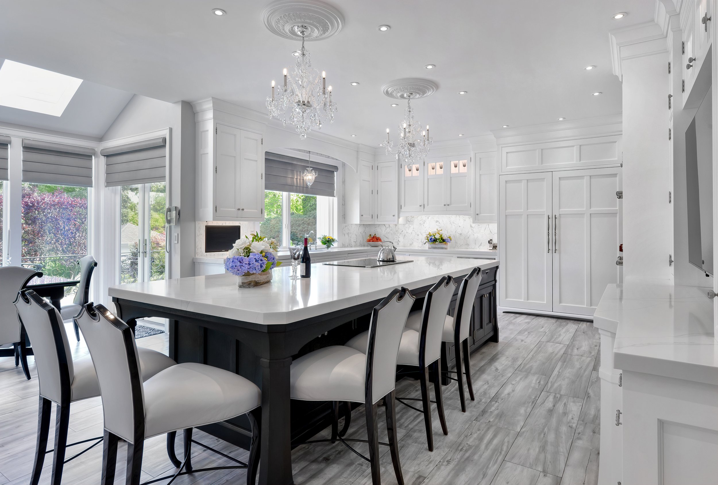Custom wood kitchen with walnut and white cabinets,. Luxury Rutt brand cbainets. Oyster Bay Cove, NY full kitchen remodel. Kitchen island, kitchen chandeliers,  open concept floor plan. 
