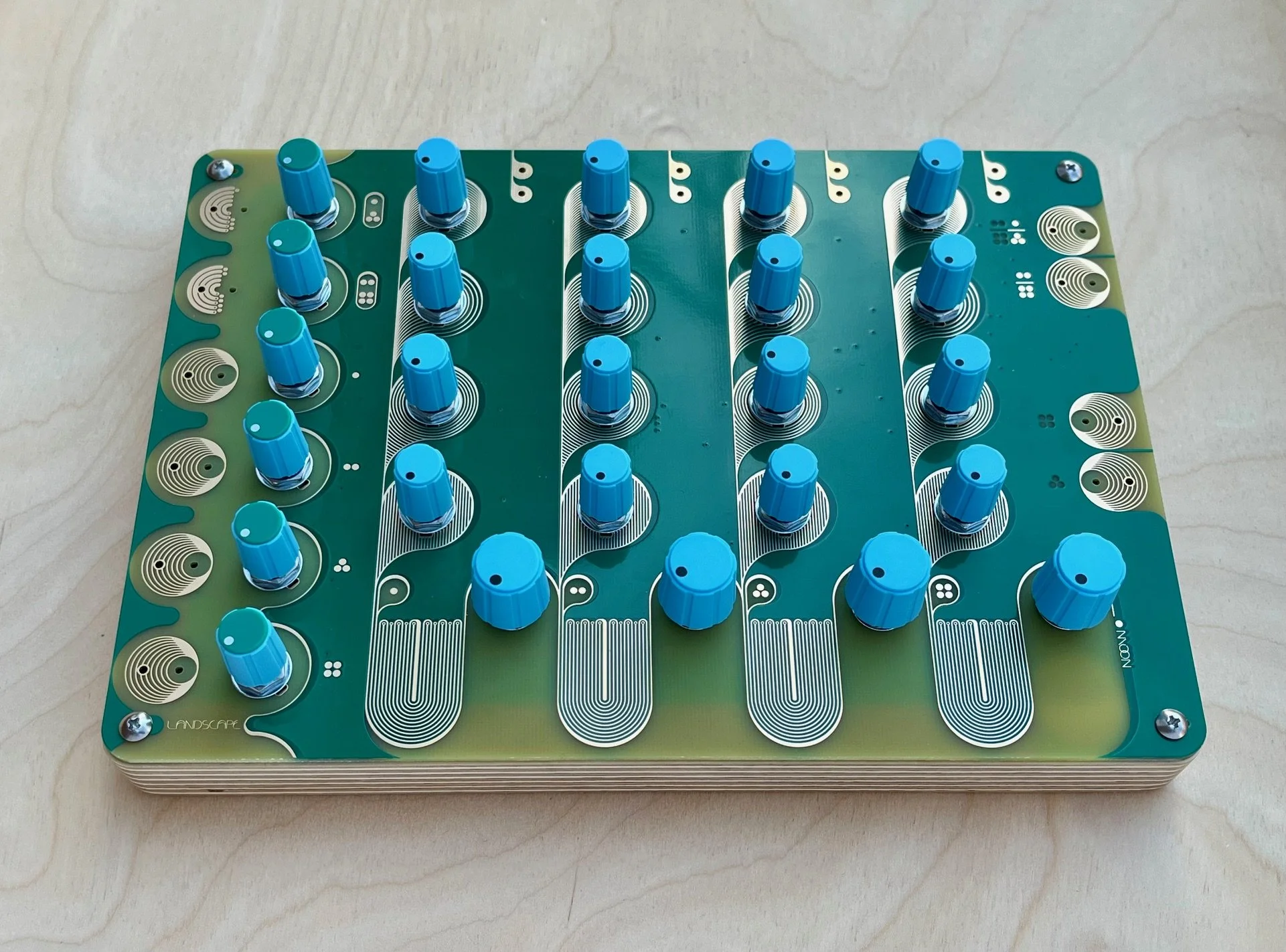 Moon, four-channel passive-analog drum synth. Blue, green, gold & wood with 26 knobs.